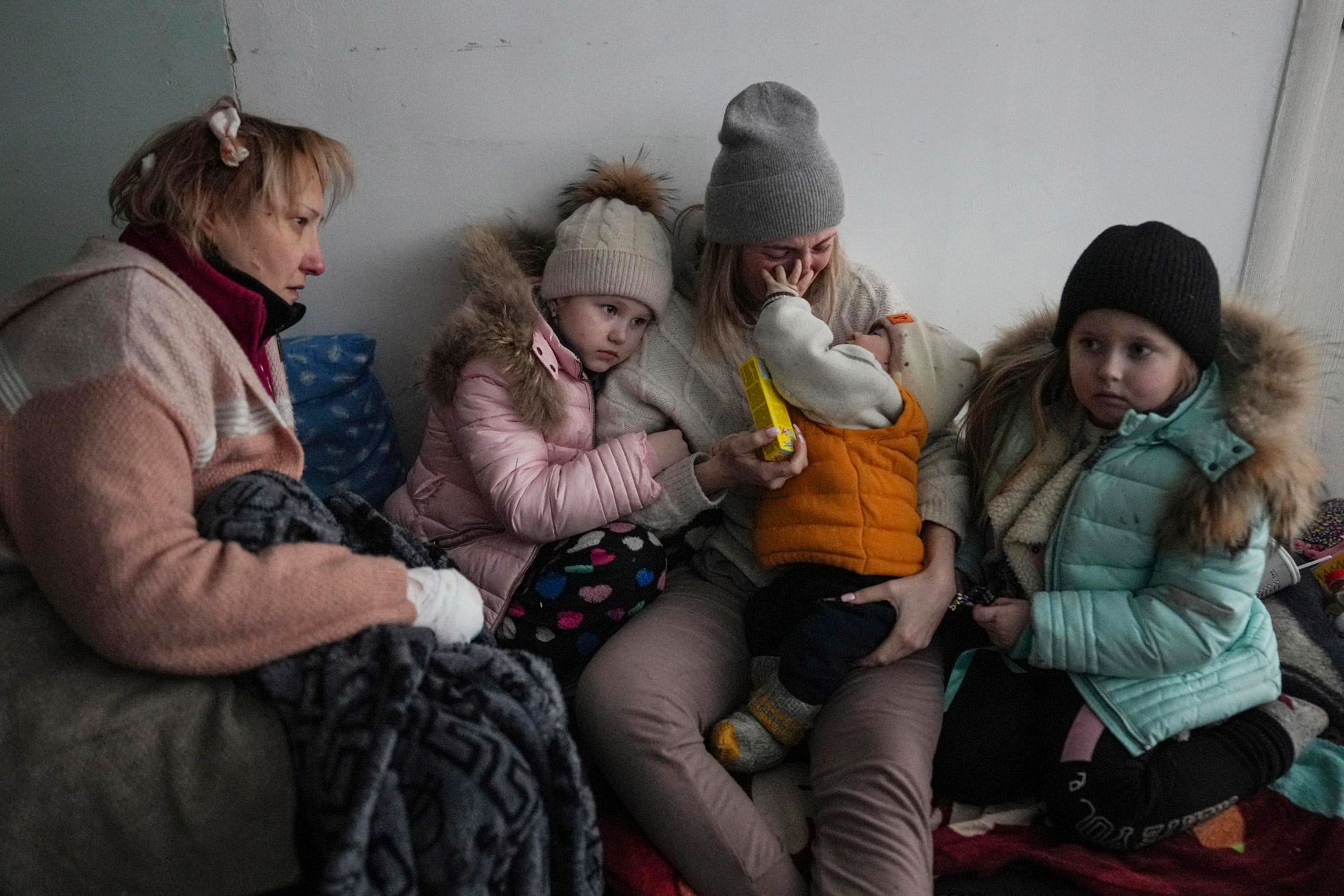 Women and children sit on the floor of a corridor in a hospital in Mariupol on March 11.