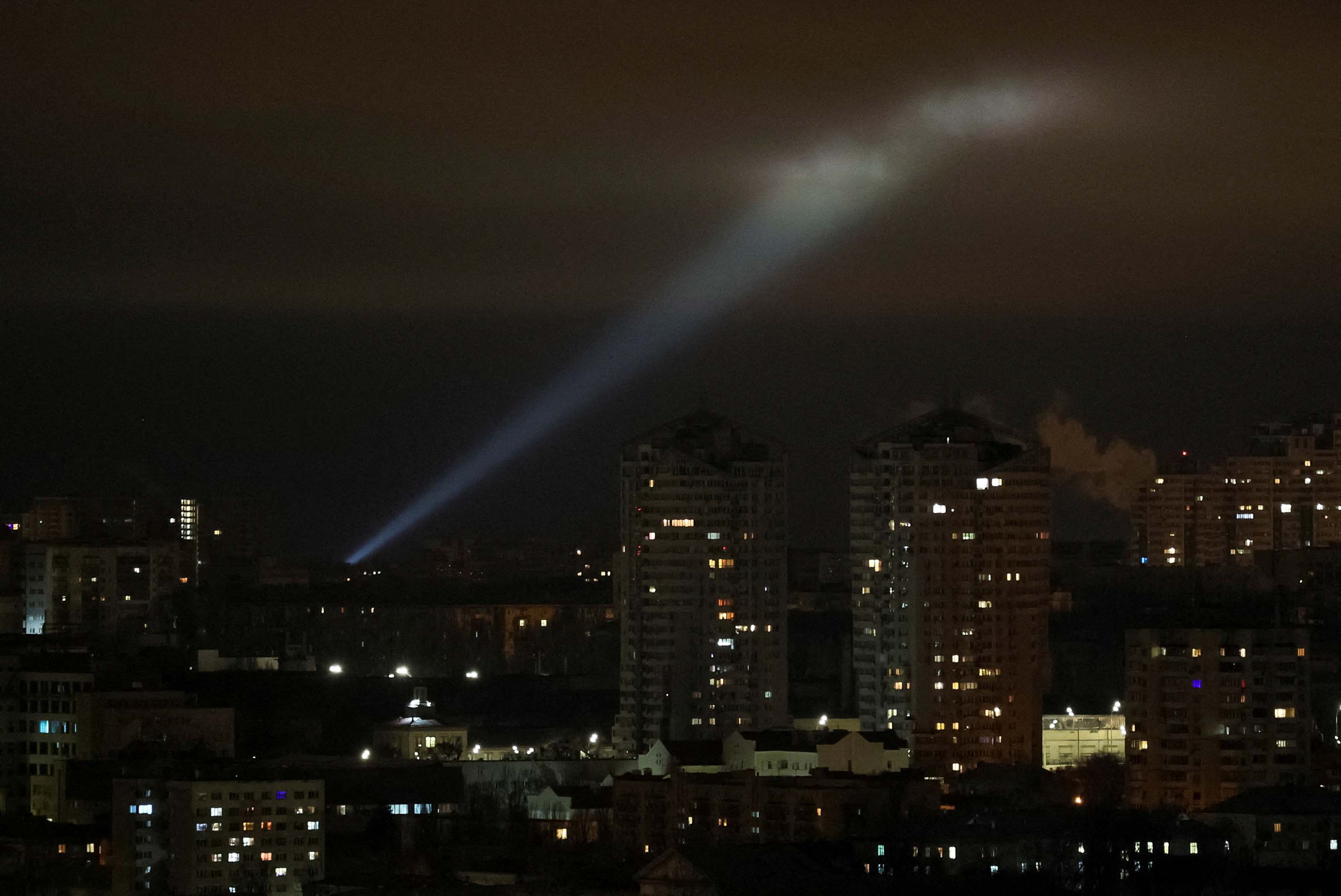 Ukrainian forces use a searchlight to scan the sky for drones over Kyiv, Ukraine, on February 27. 