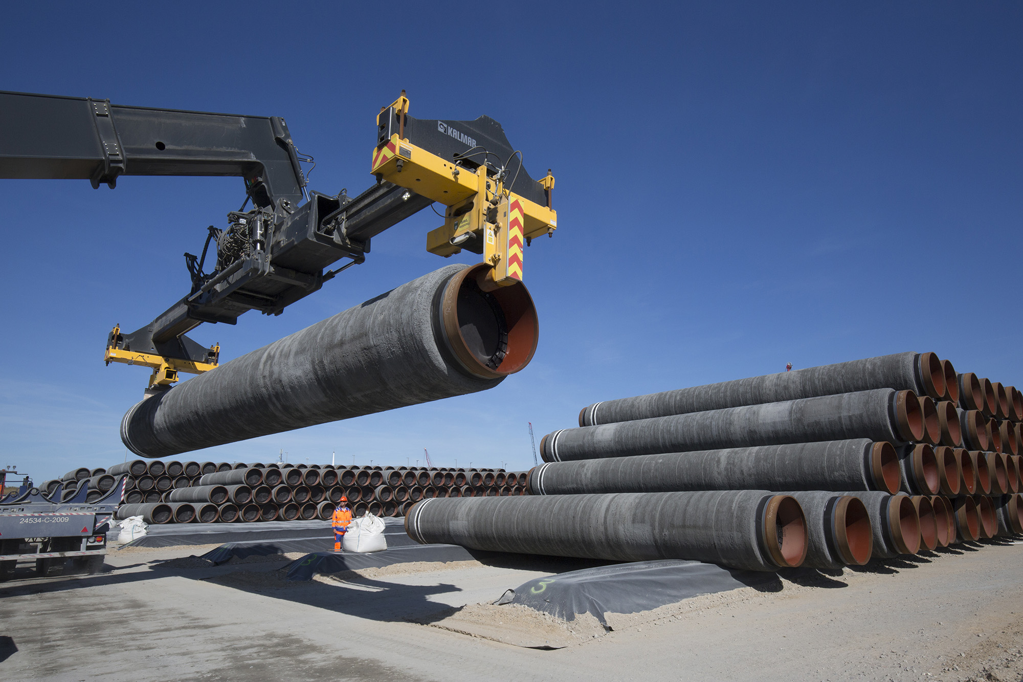 Large pipes, sheathed with a concrete iron ore mixture, for the Baltic Sea pipeline Nord Stream 2 are positioned at a storage area in the ferry port of Sassnitz/Neu Mukran in Germany on June 5, 2018.