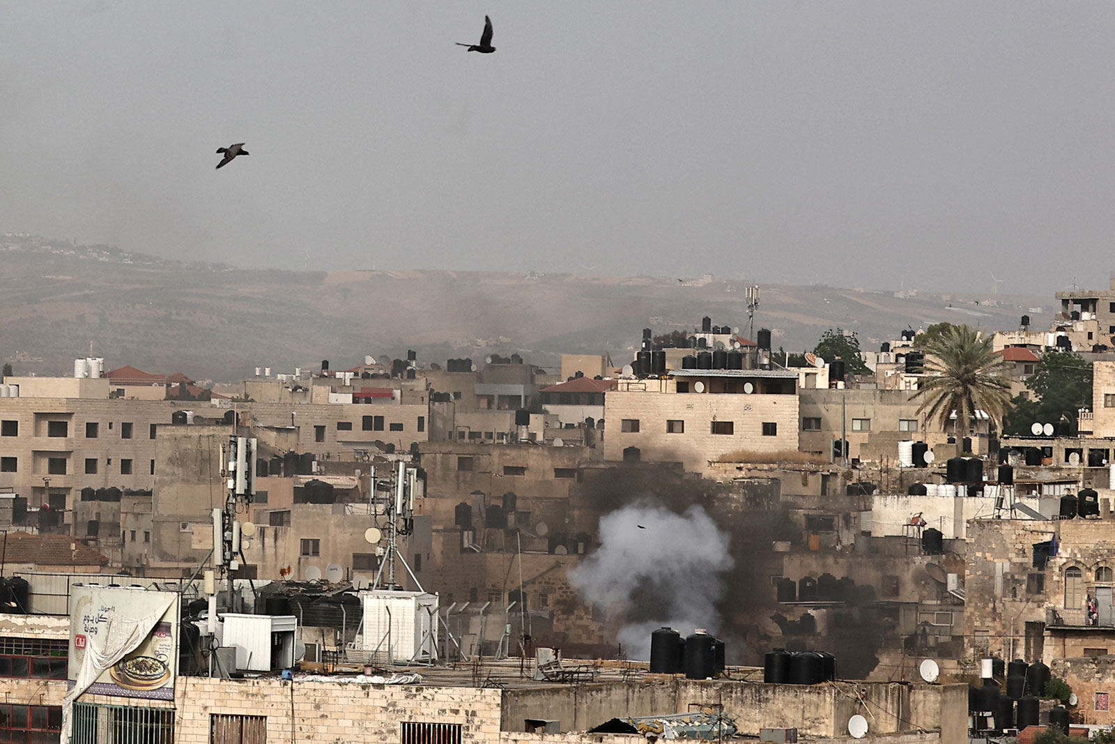 Smoke rises as ann Israeli raid on the West Bank city of Jenin stretched into a second day on Wednesday, May 22.