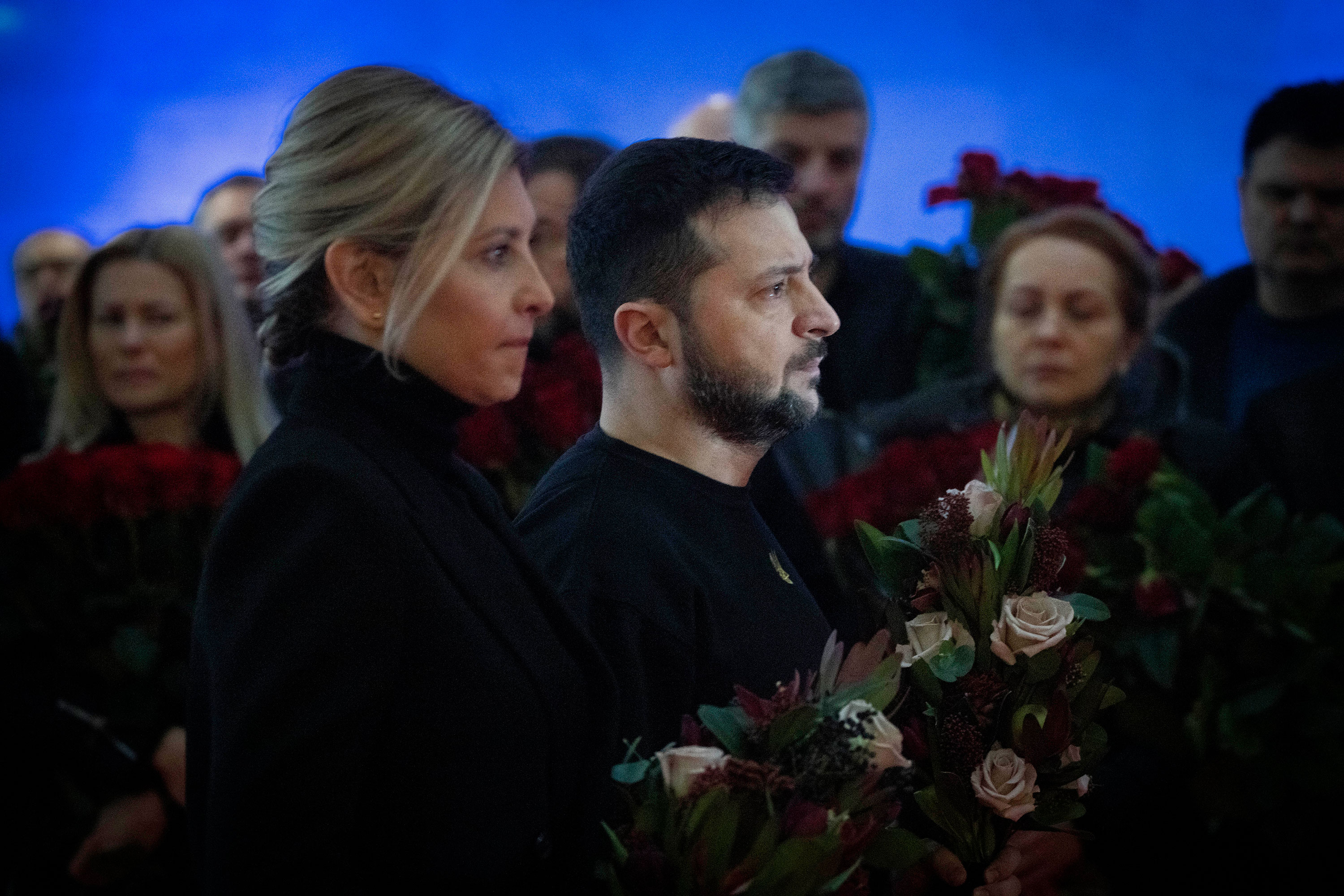 Ukrainian President Volodymyr Zelensky and his wife Olena pay their respects to victims of a deadly helicopter crash during a farewell ceremony Saturday in Kyiv.