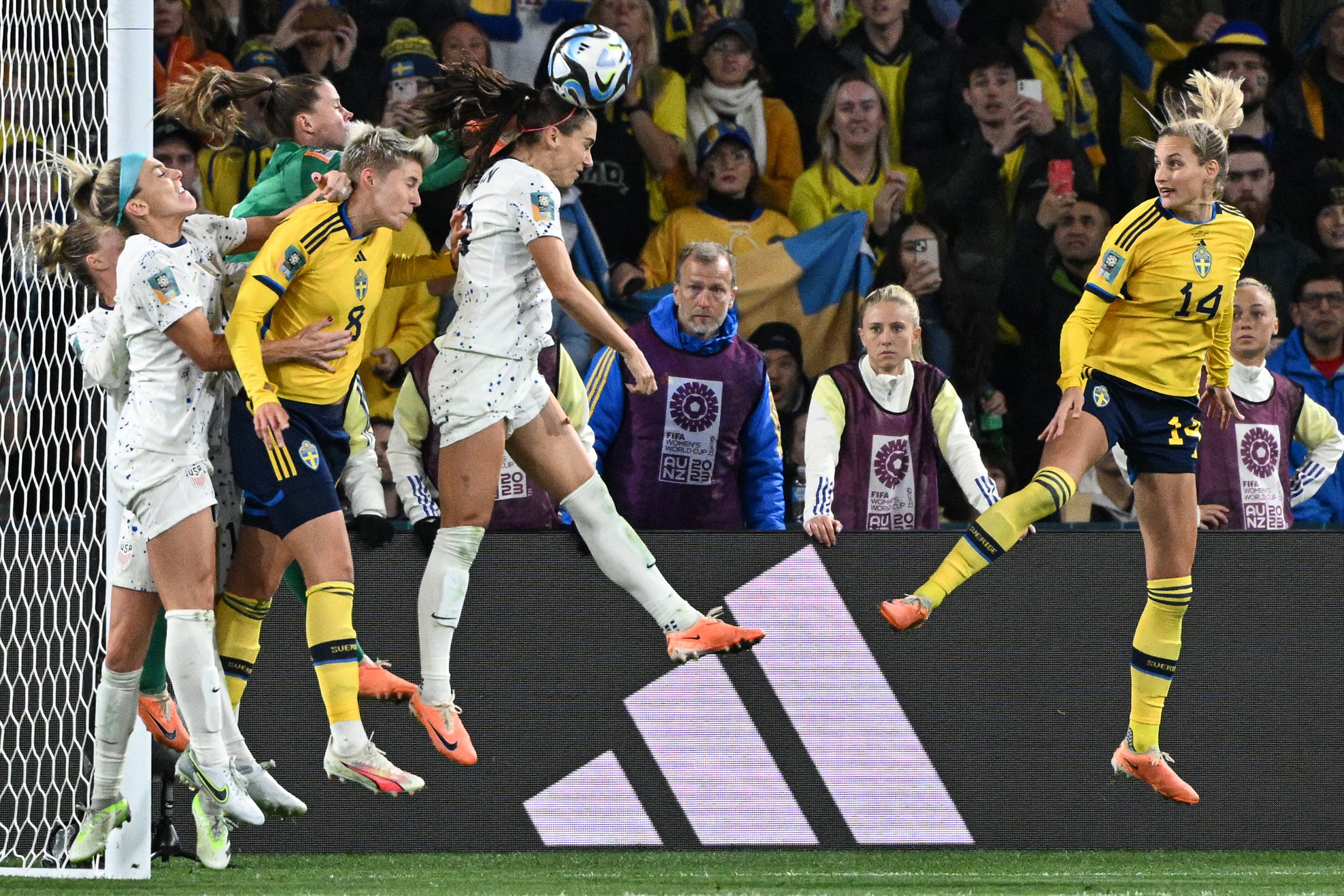 US forward Alex Morgan, center, heads the ball during the match against Sweden. 