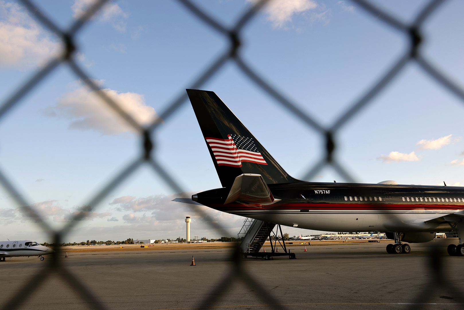 Seen through a security fence, the Trump Organization's Boeing 757 used by former U.S. President Donald Trump, known as Trump Force One, sits parked on the tarmac at the Palm Beach International Airport on March 31 in West Palm Beach, Florida.
