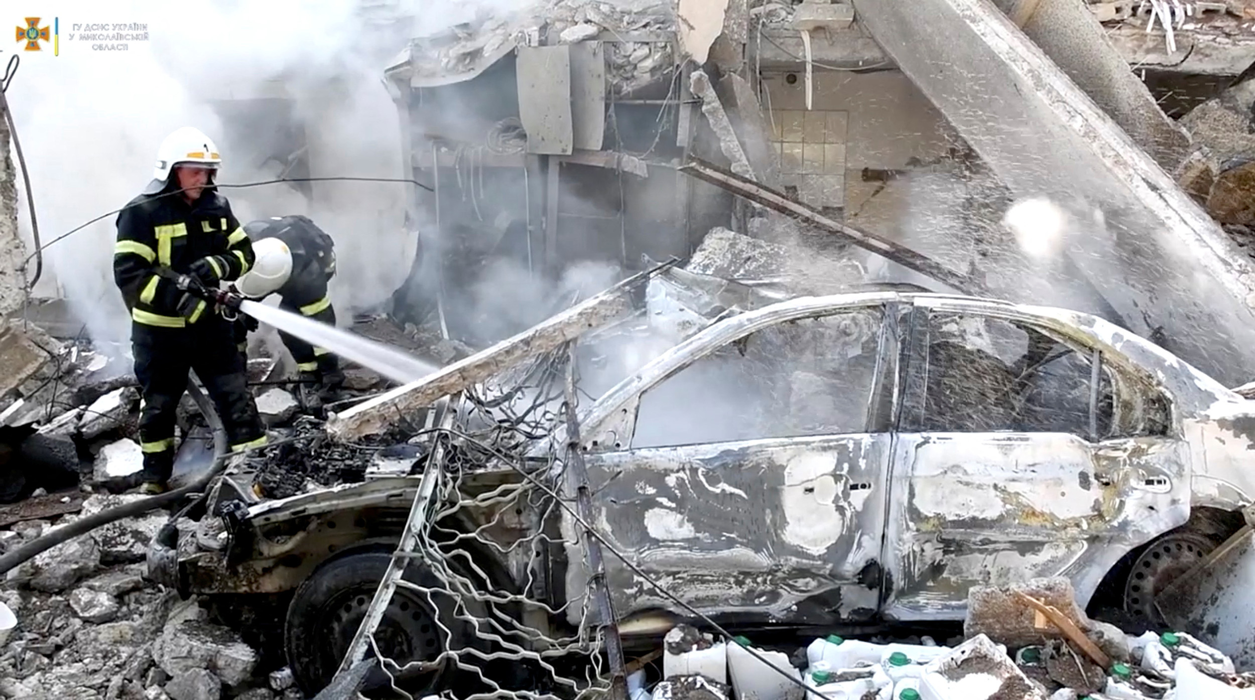 Firefighters work at the site of a Russian military strike in Mykolaiv, Ukraine, in this screengrab taken from a handout video released on July 15.