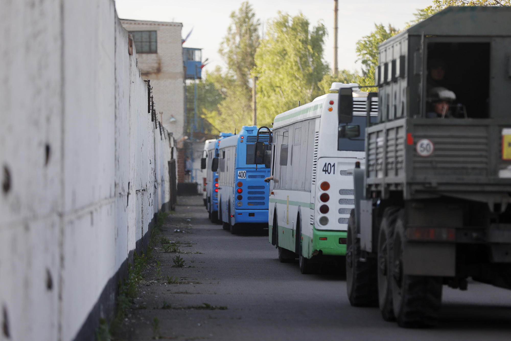 Buses with Ukrainian servicemen evacuated from Azovstal steel plant in Mariupol, stand near a prison in Olyonivka, territory under the government of the Donetsk People's Republic in eastern Ukraine, on May 17.