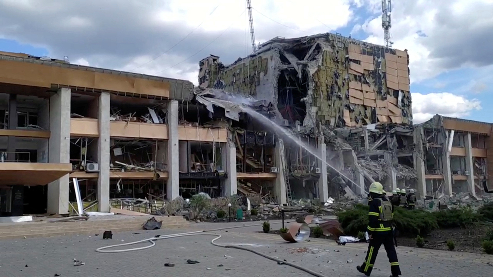 Firefighters work at the scene after an airstrike on the Cultural Center, in Lozova, Kharkiv region, Ukraine on Friday, May 20.