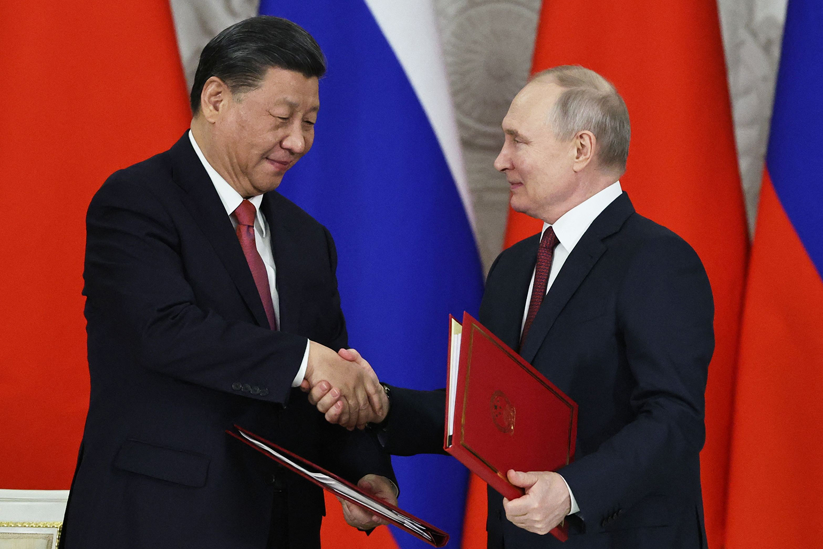 Russian President Vladimir Putin and China's President Xi Jinping shake hands during a signing ceremony following their talks at the Kremlin in Moscow on March 21. 