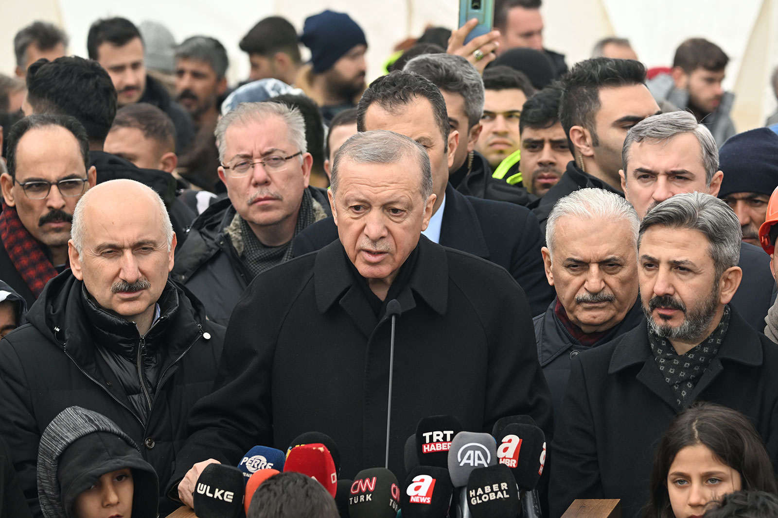 Turkish President Recep Tayyip Erdogan speaks to the press after visiting a tent city in Adiyaman, Turkey, on Friday. 