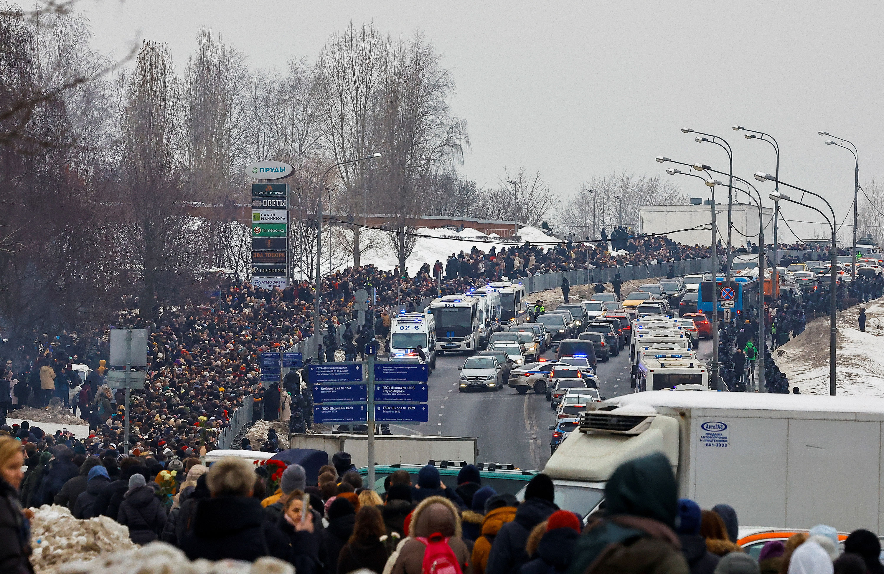 People walk towards the Borisovsky cemetery in Moscow after the funeral service.