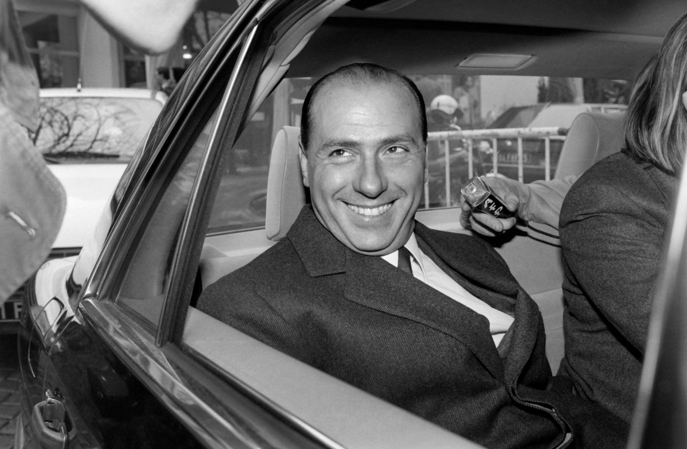 Silvio Berlusconi is pictured leaving a news conference in Paris in 1985.