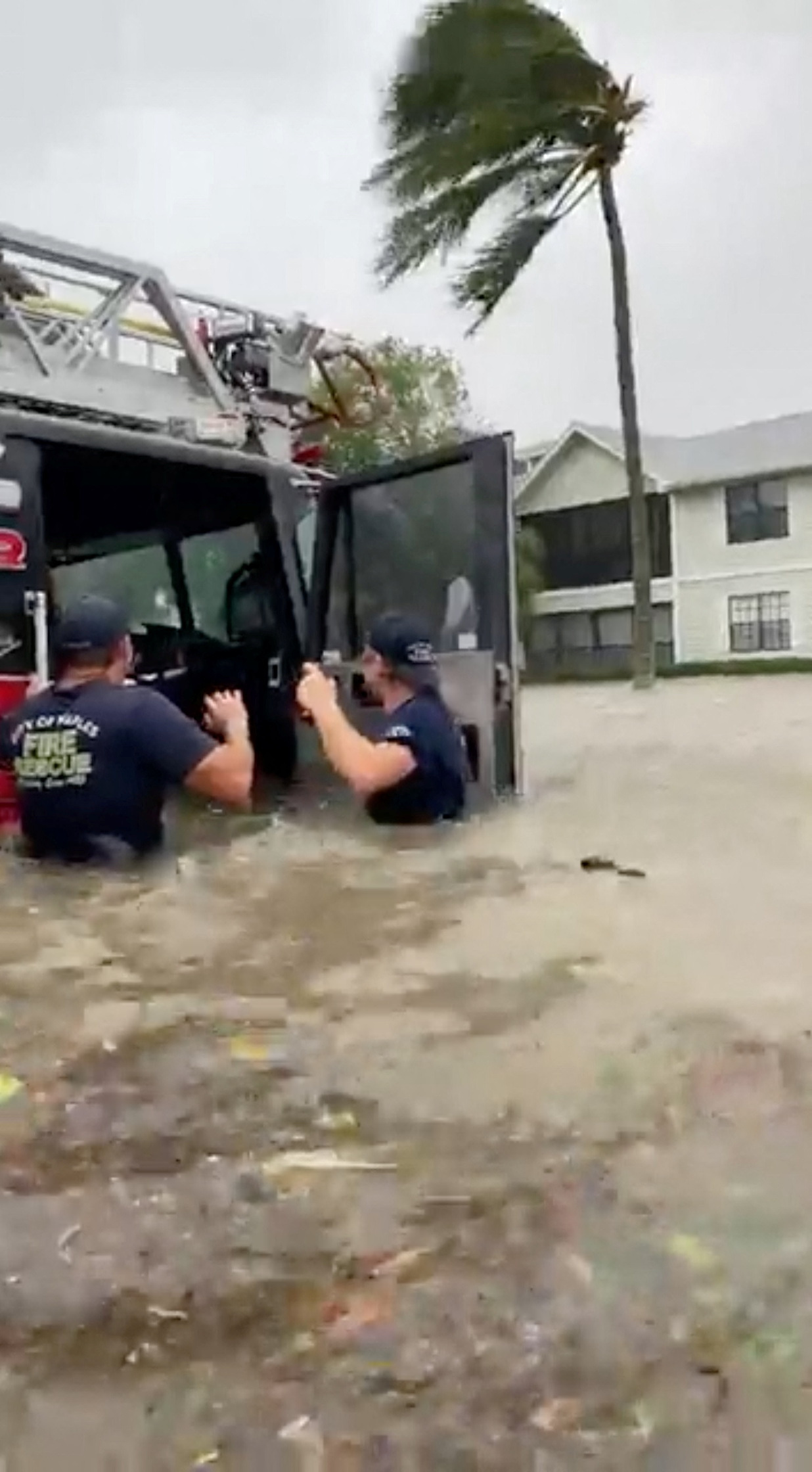 Firefighters work as the fire station gets inundated in Naples, Florida, U.S., on September 28, in this screenshot taken from a social media video. 