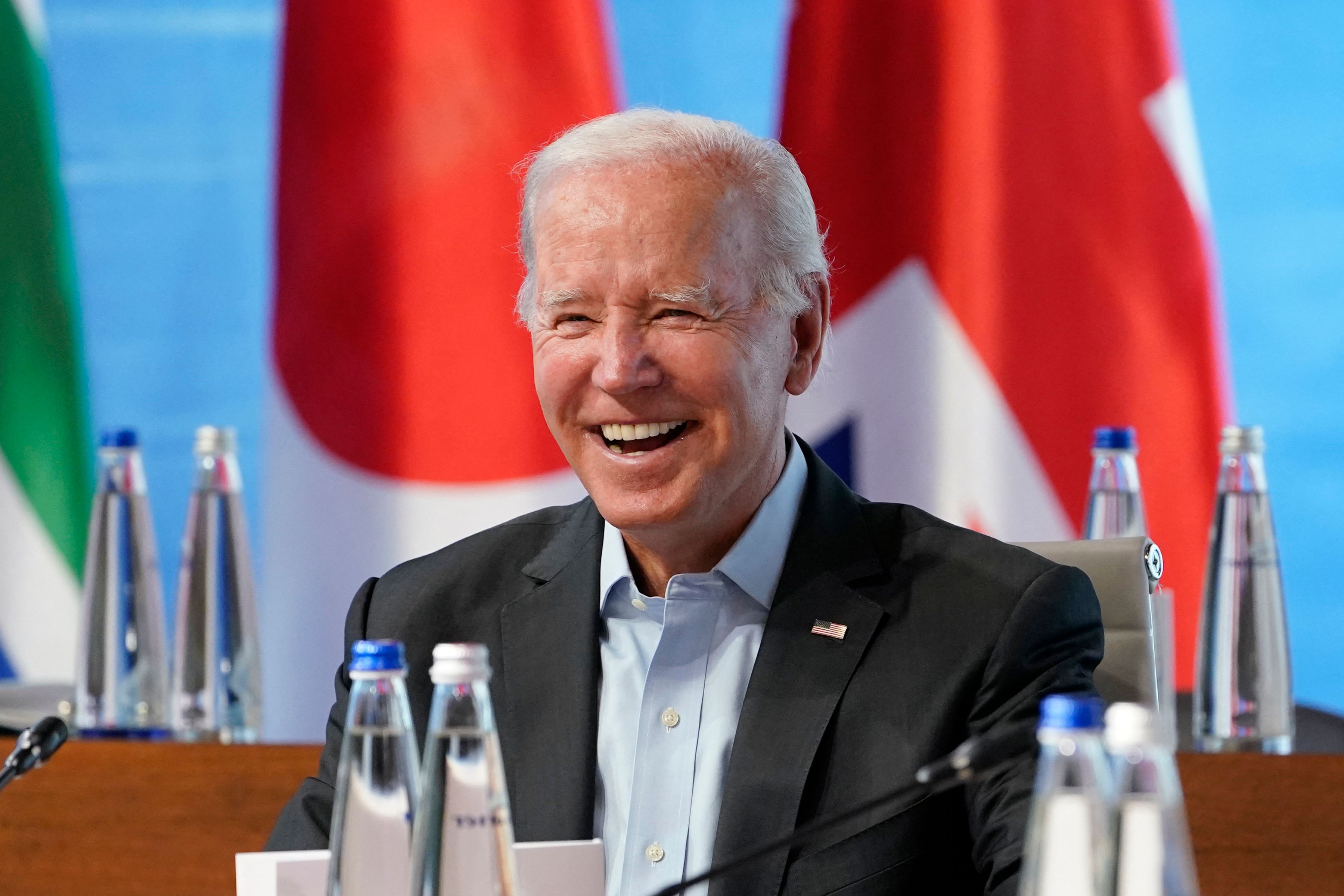 US President Joe Biden smiles at the start of a lunch with Representatives of Seven rich nations (G7) and Outreach guests during their fifth working session about "Investing in a better future: Climate, Energy, Health" on June 27, at Elmau Castle, Germany.