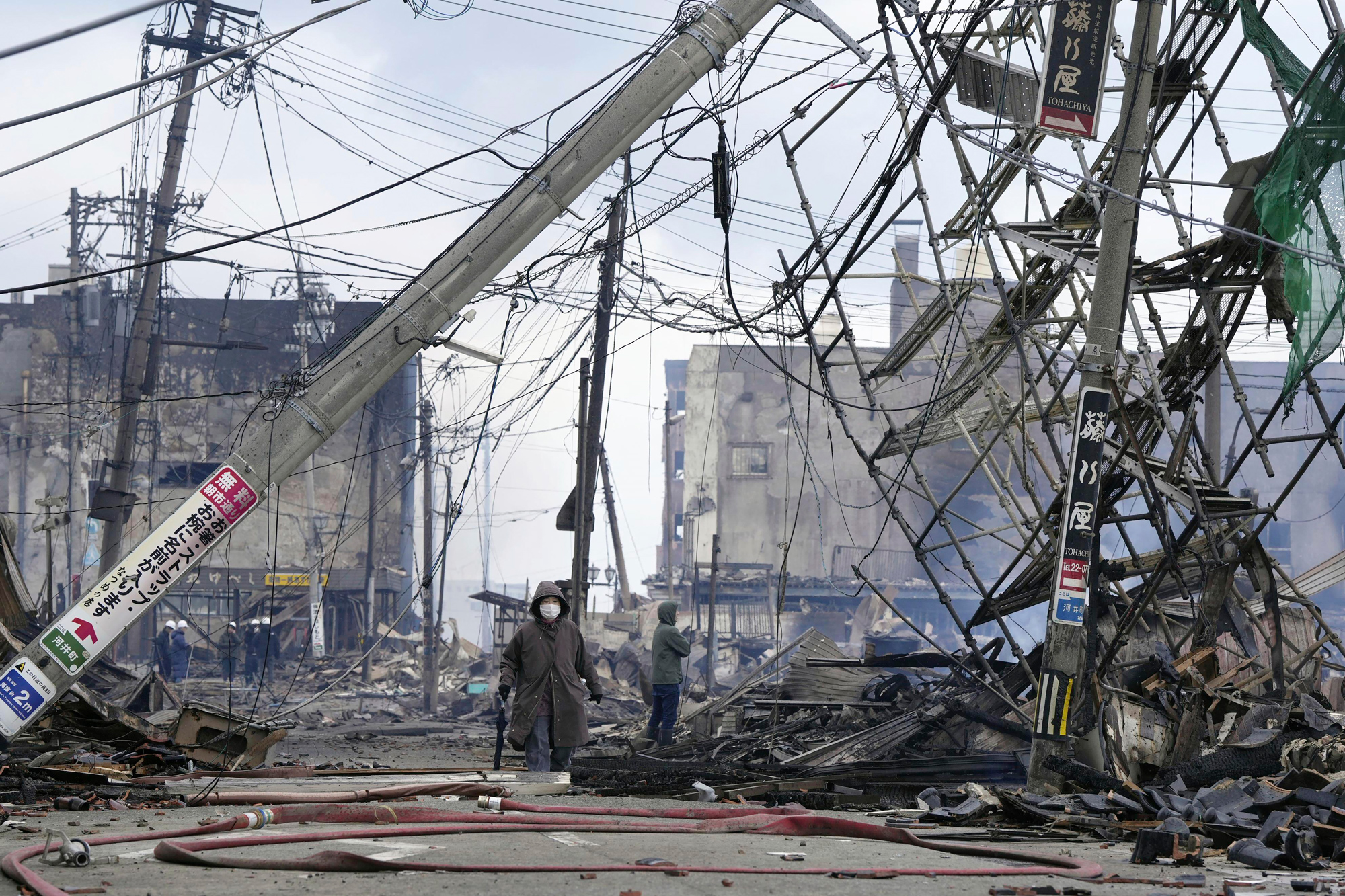 People walk through the damaged marketplace burnt by fire after the earthquake, in Wajima, Ishikawa prefecture, Japan, on January 2.