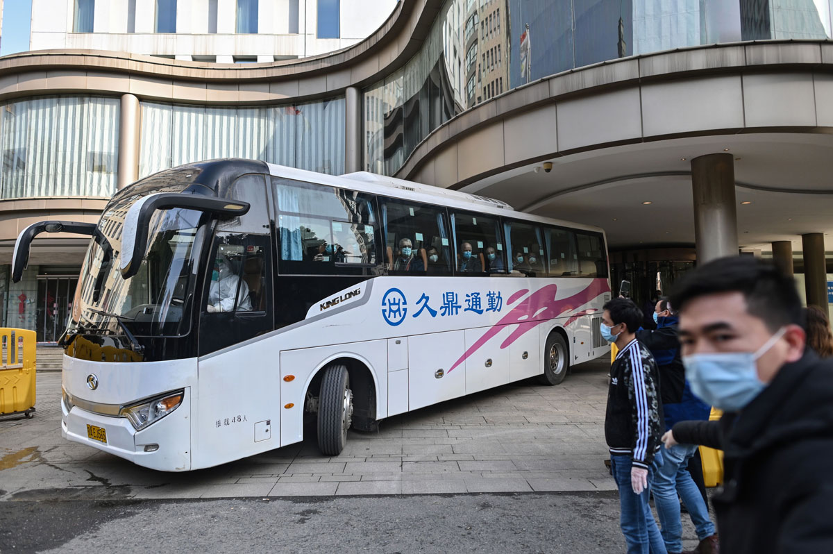 Members of the World Health Organization team investigating the origins of the Covid-19 coronavirus pandemic leave The Jade Hotel on a bus after completing their quarantine in Wuhan, China on January 28.