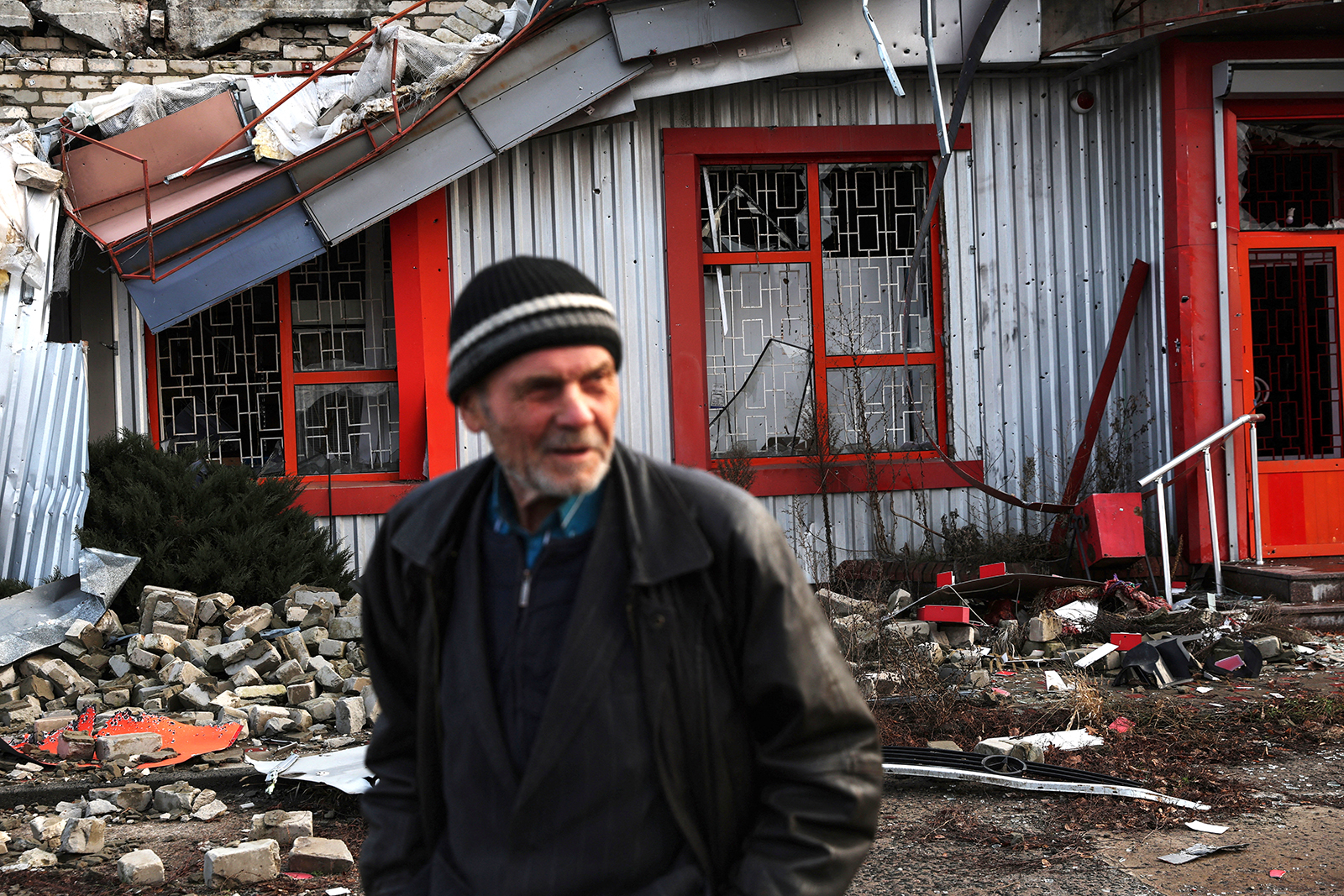 A man walks past a damaged building in Donetsk region on December 11.