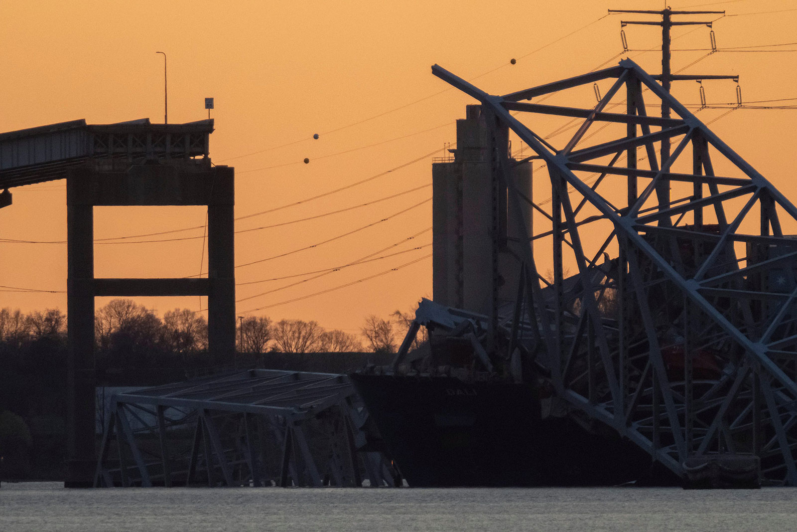 The sun sets on the Francis Scott Key Bridge on Thursday, March 28.
