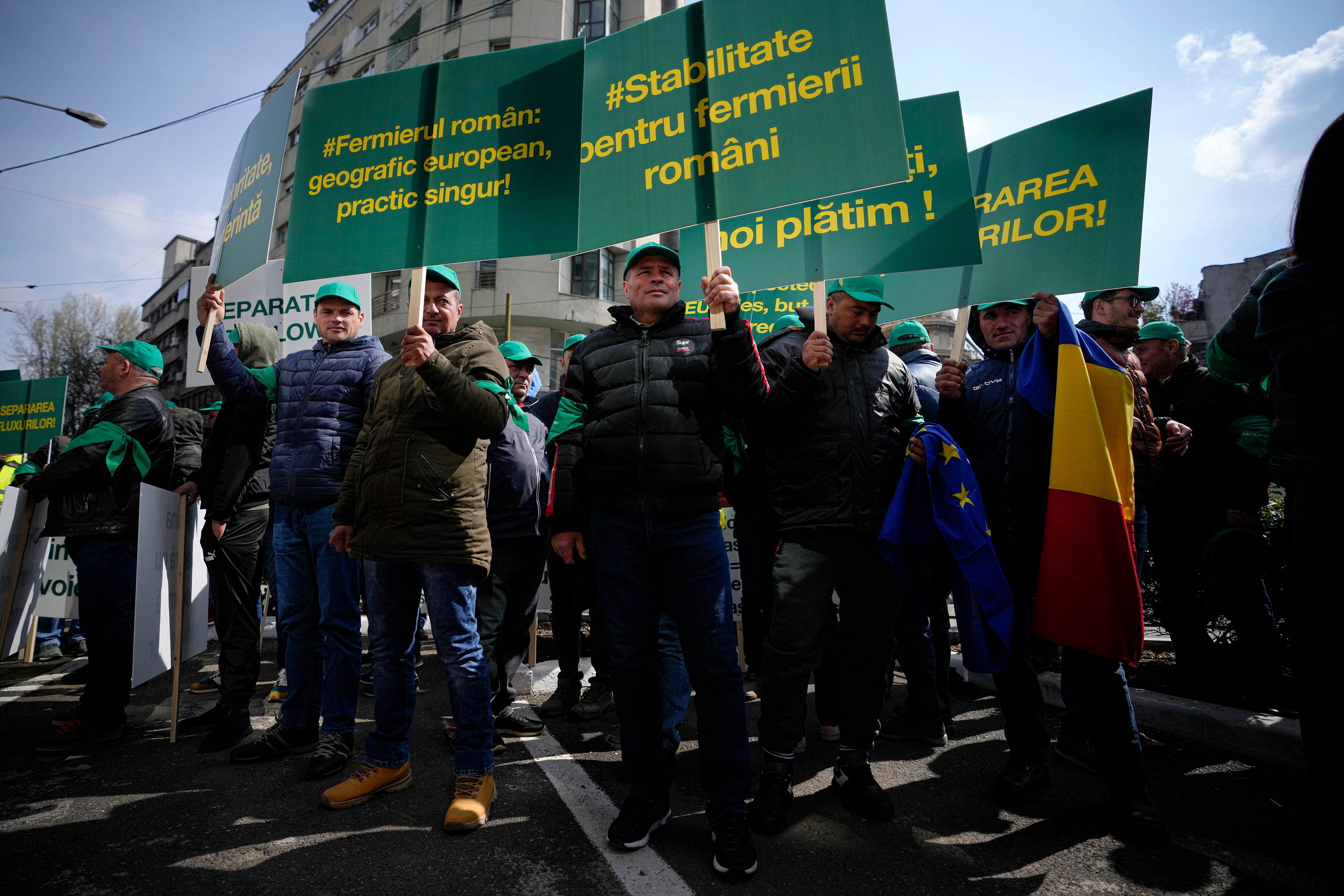 Protesters carry signs in Bucharest, Romania, on Friday. 