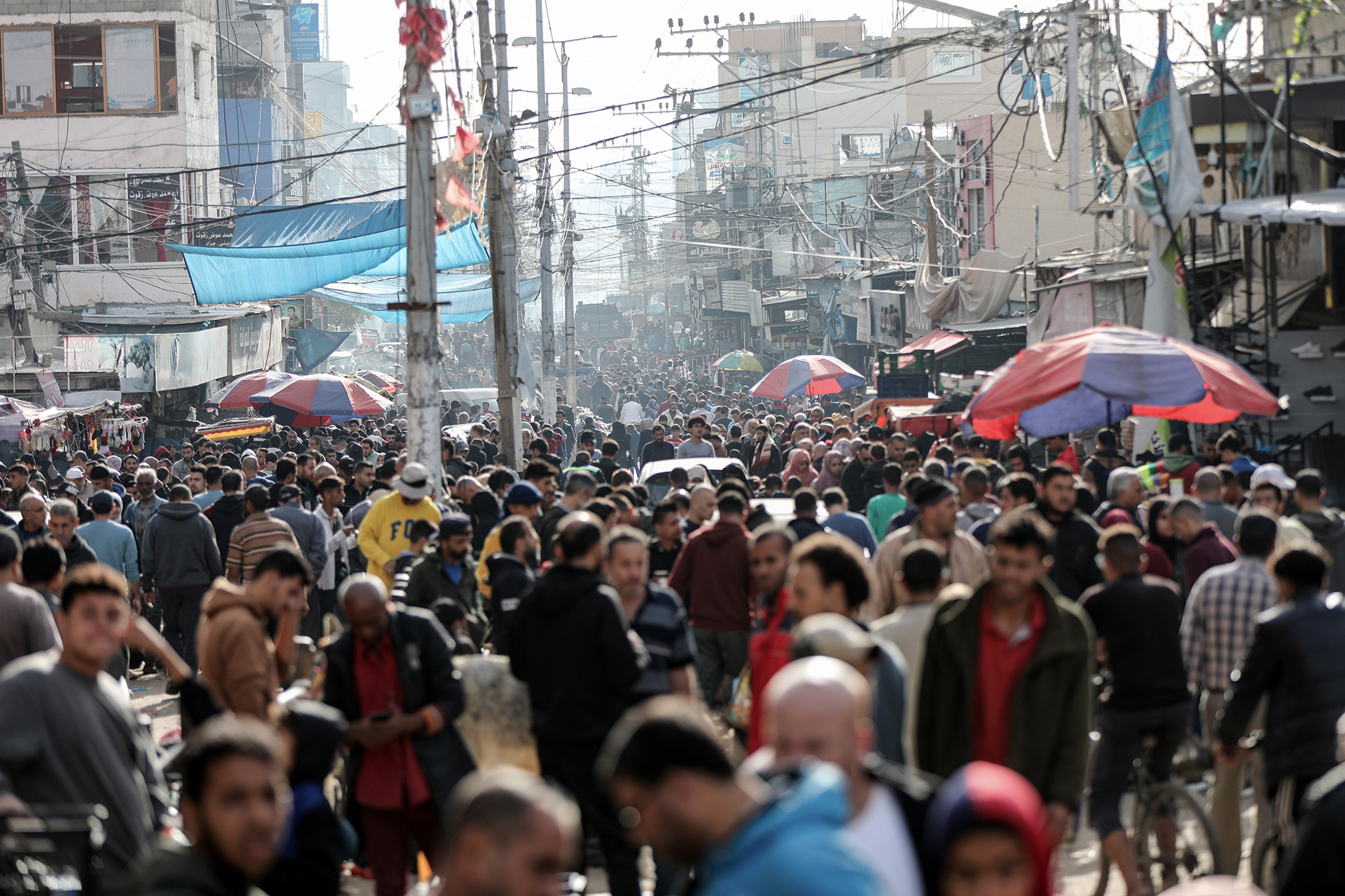 Palestinians flock to markets and shops during the second day of the humanitarian pause in Khan Younis, Gaza, on November 25.