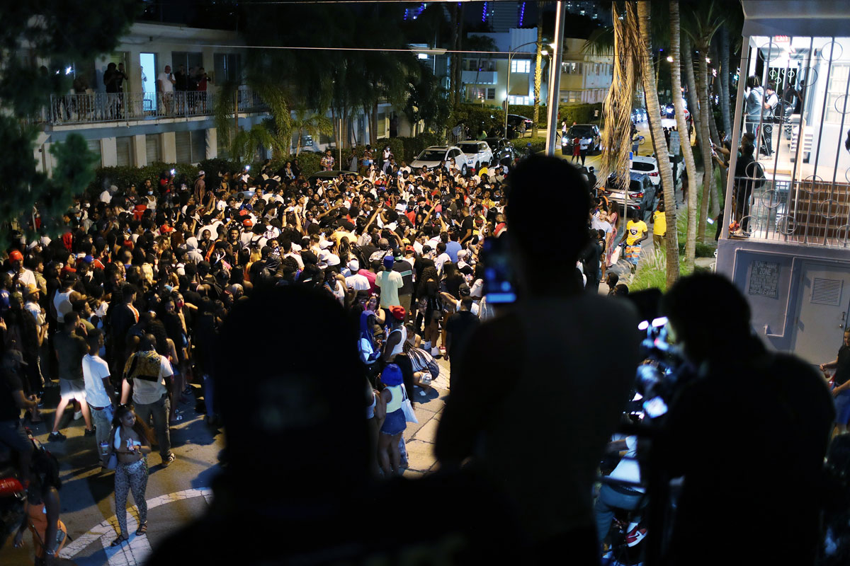 People gather in Miami Beach, Florida as an 8pm curfew goes into effect on March 21.