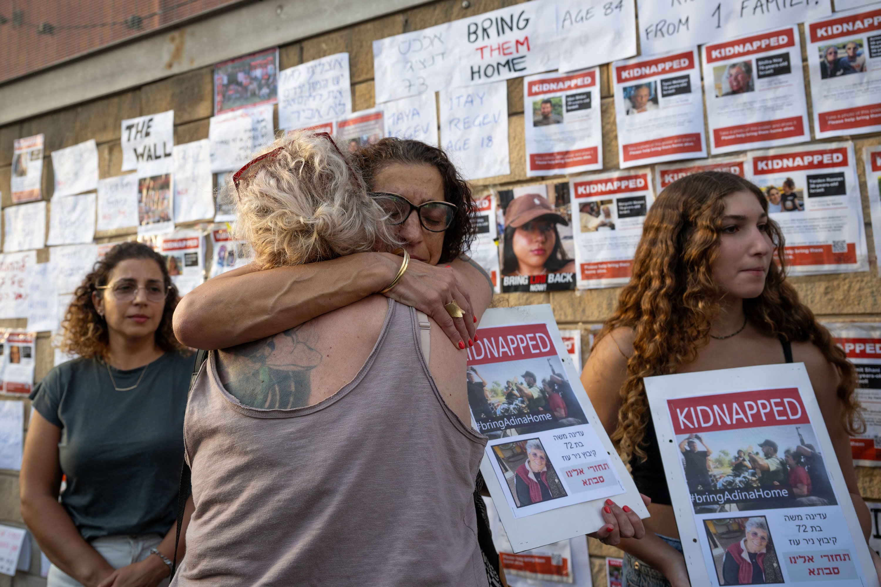 Einav Moshe Barda, the niece of Adina, who was kidnapped, hugs a woman after telling her family's story on Saturday, October 14, outside HaKirya, the government and military quarters in Tel Aviv, Israel. 