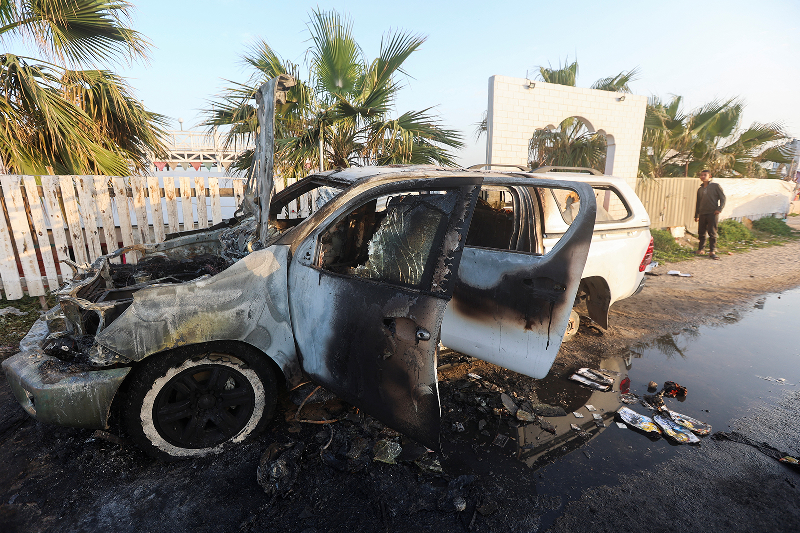 A person looks at a vehicle where employees from the World Central Kitchen (WCK), including foreigners, were killed in an Israeli airstrike, in Deir Al-Balah, Gaza, on April 2.