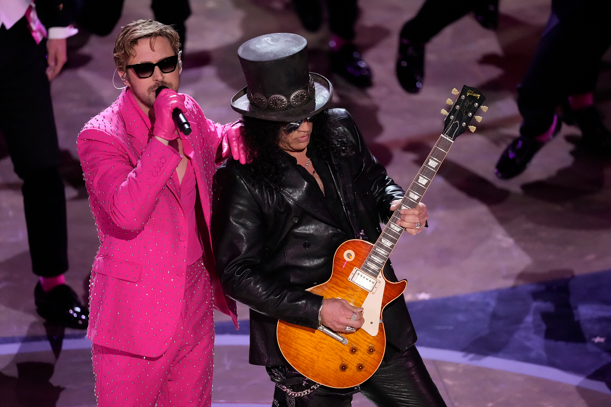 Ryan Gosling, left, performs onstage with Slash. 