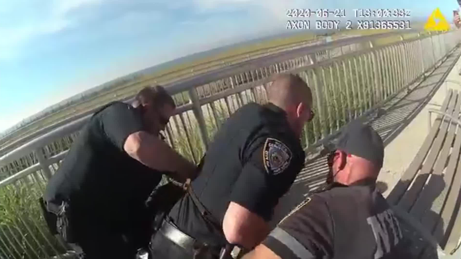The video shows several officers arresting a man, with one officer appearing to put him in a chokehold. 