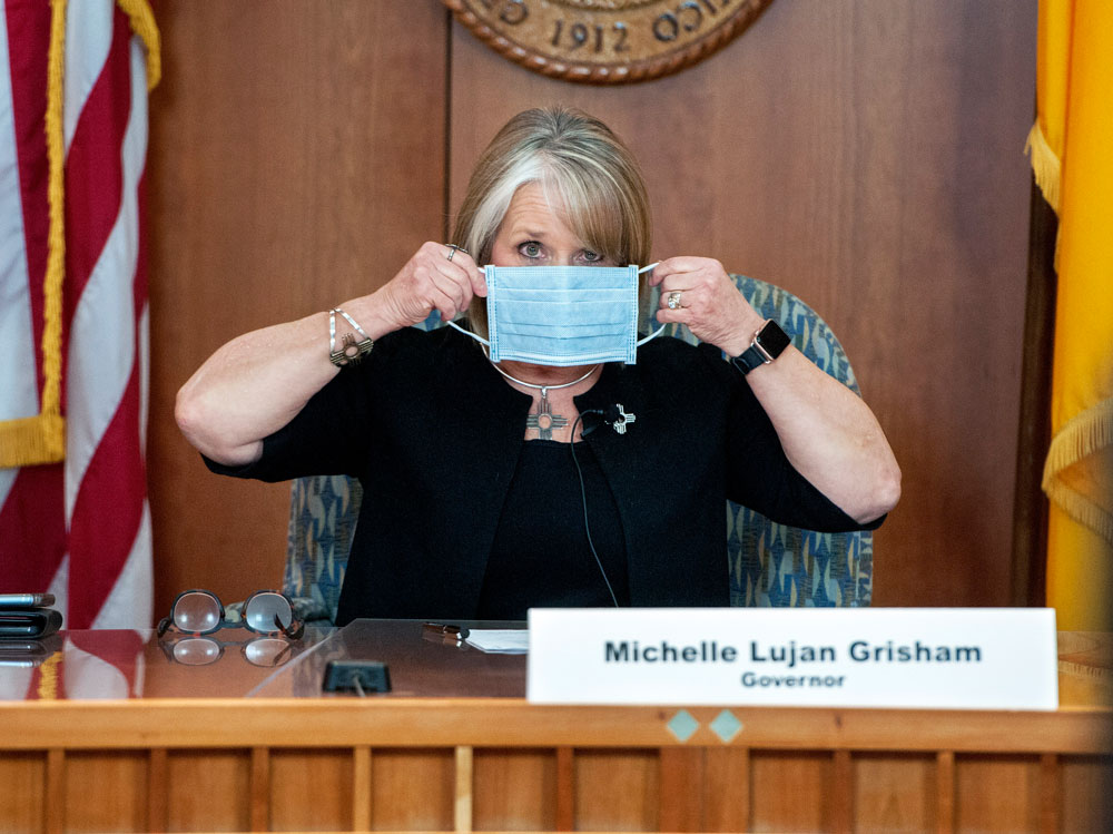 New Mexico Gov. Michelle Lujan Grisham puts on her face mask when not speaking during an update on the coronavirus outbreak during a news conference in Santa Fe, New Mexico, on Wednesday, April 15. 