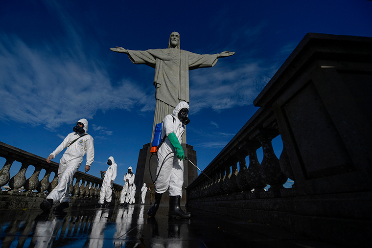 Soldiers of the Brazilian Armed Forces disinfect the Christ The Redeemer statue at the Corcovado mountain prior to the opening of the attraction on August 15, in Rio de Janeiro, Brazil, on August 13.