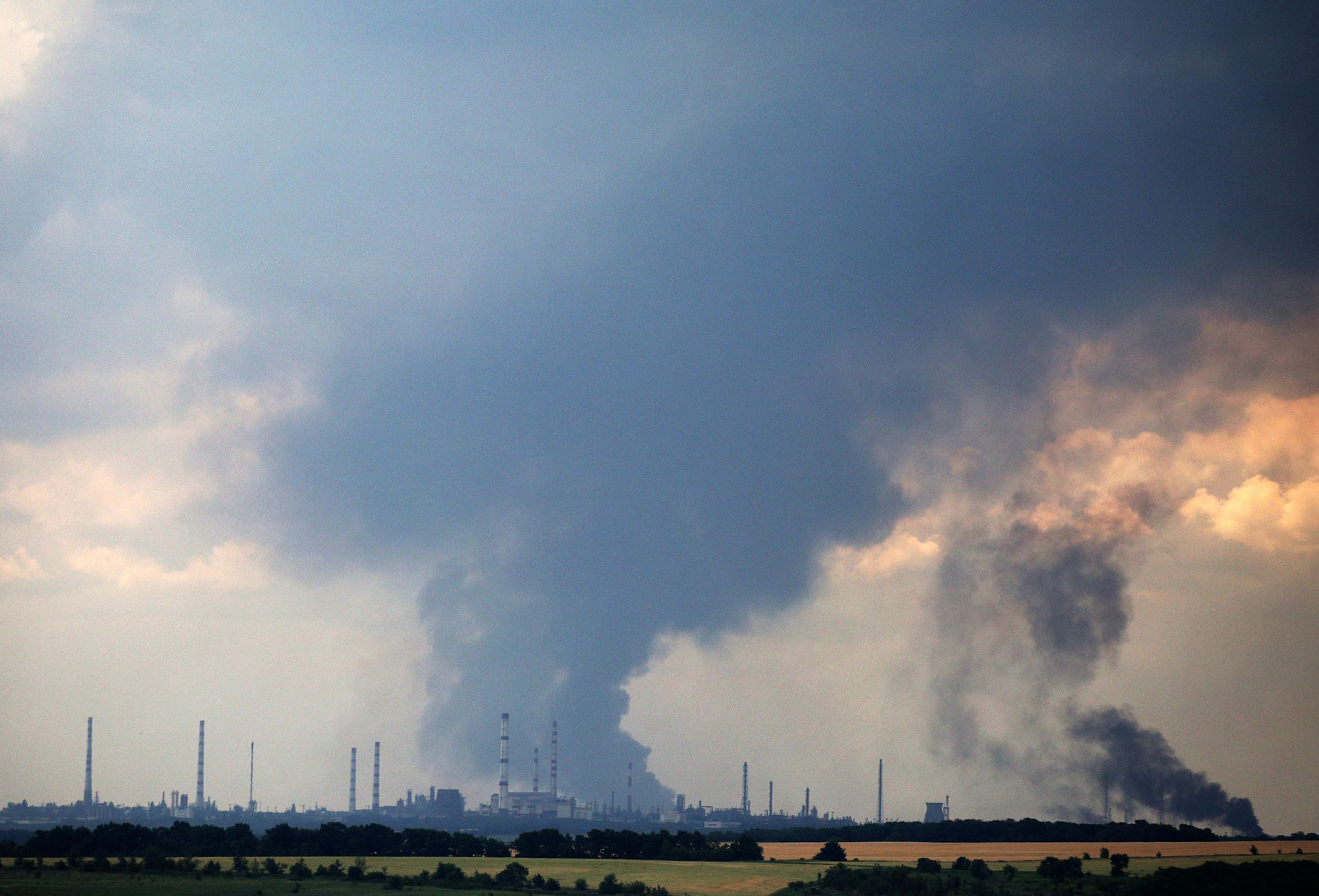 Smoke billows over the oil refinery outside Lysychansk, Ukraine, on June 23.