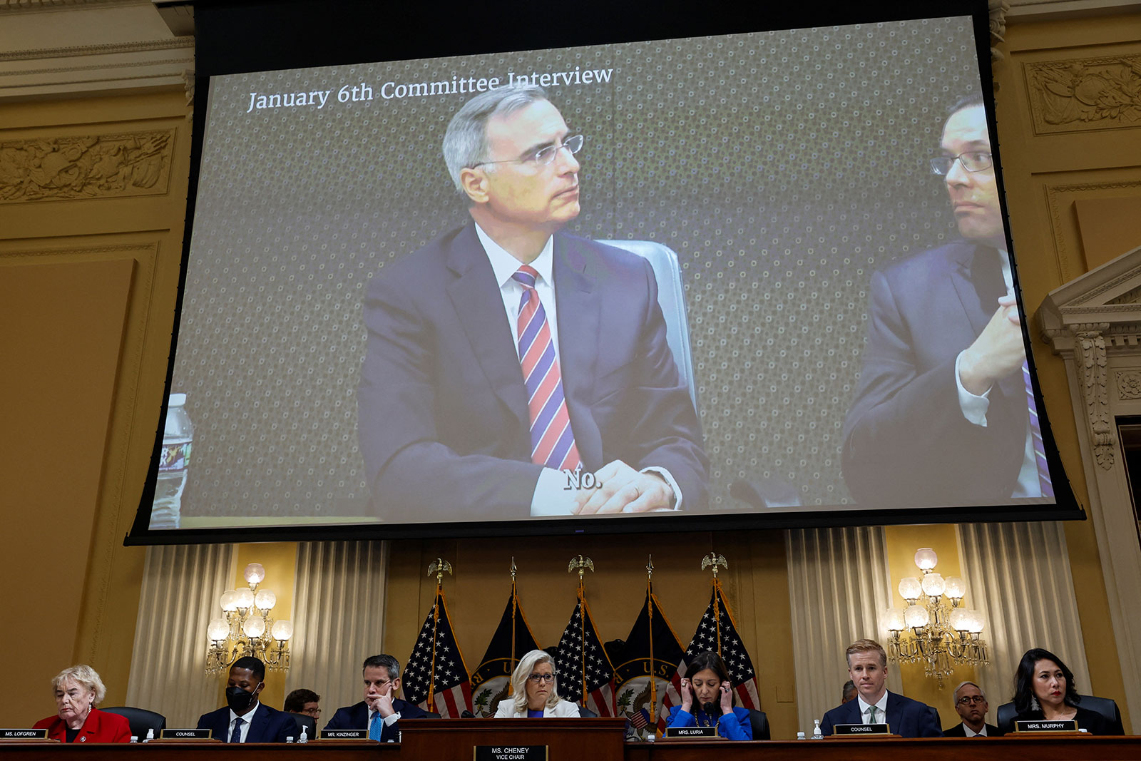 A recorded video of former White House counsel Pat Cipollone is displayed on a screen during Thursday's House select committee hearing. 