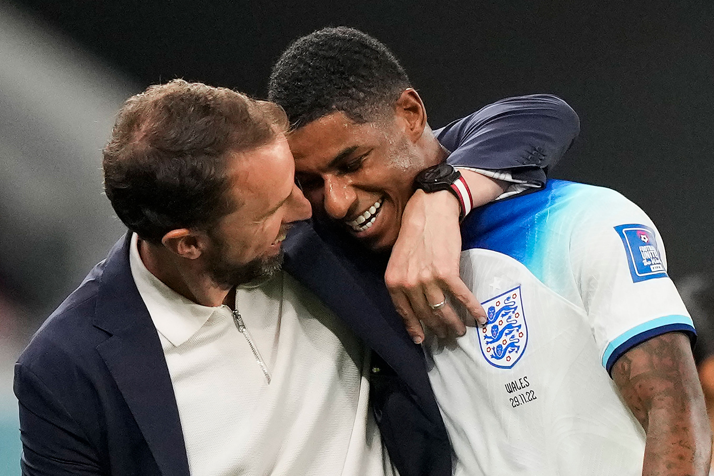 England's Marcus Rashford, right, is greeted by England's head coach Gareth Southgate as he leaves the pitch during the match against Wales.