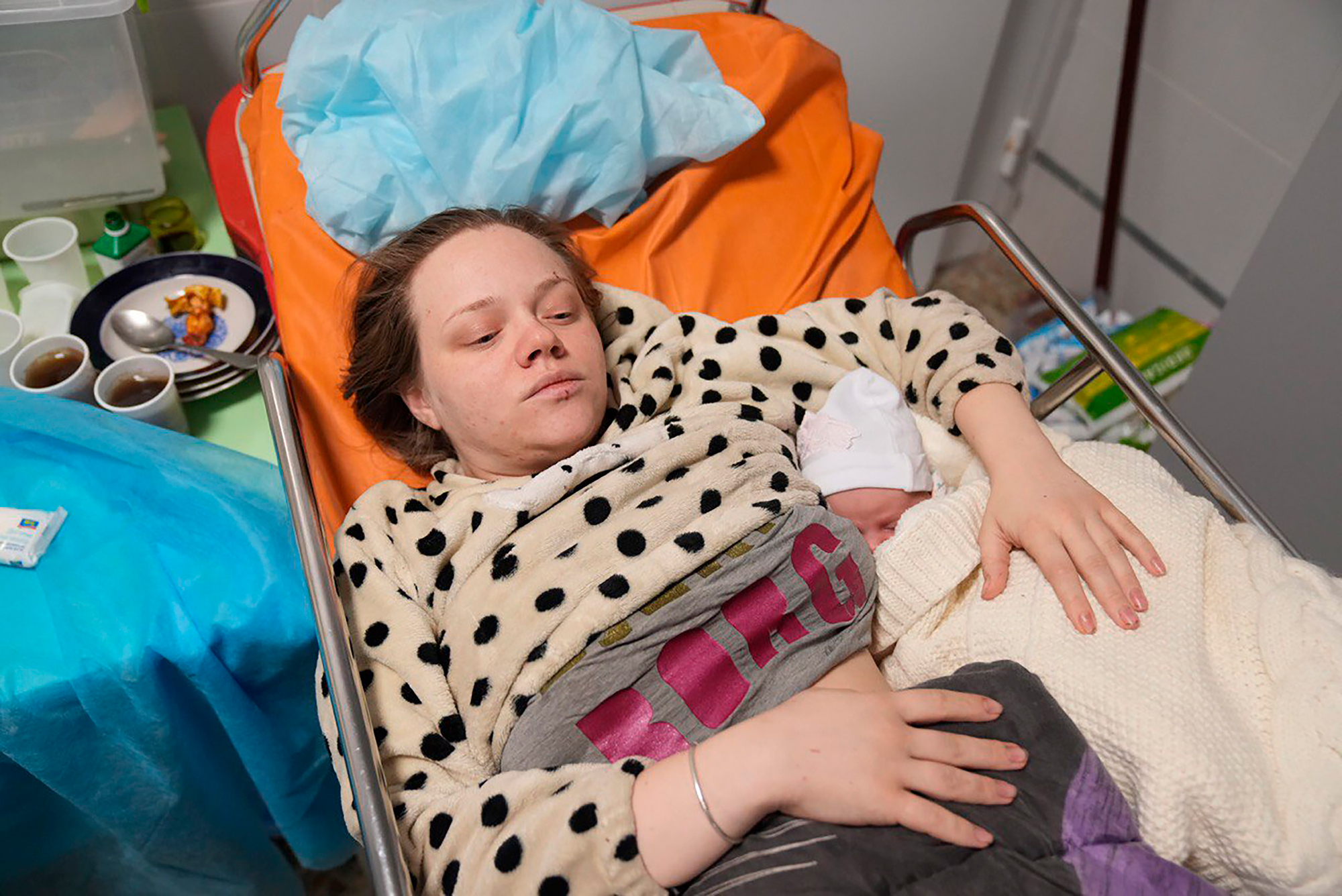 Vishegirskaya lies in a hospital bed after giving birth to her daughter Veronika on Friday in Mariupol.