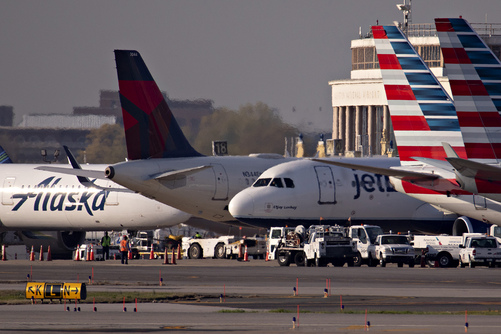 A JetBlue Airways Corp. plane taxis next to American Airlines Group Inc., Delta Air Lines Inc., and Alaska Airlines Inc. aircraft at Reagan National Airport (DCA) in Arlington, Virginia, on Monday, April 6.
