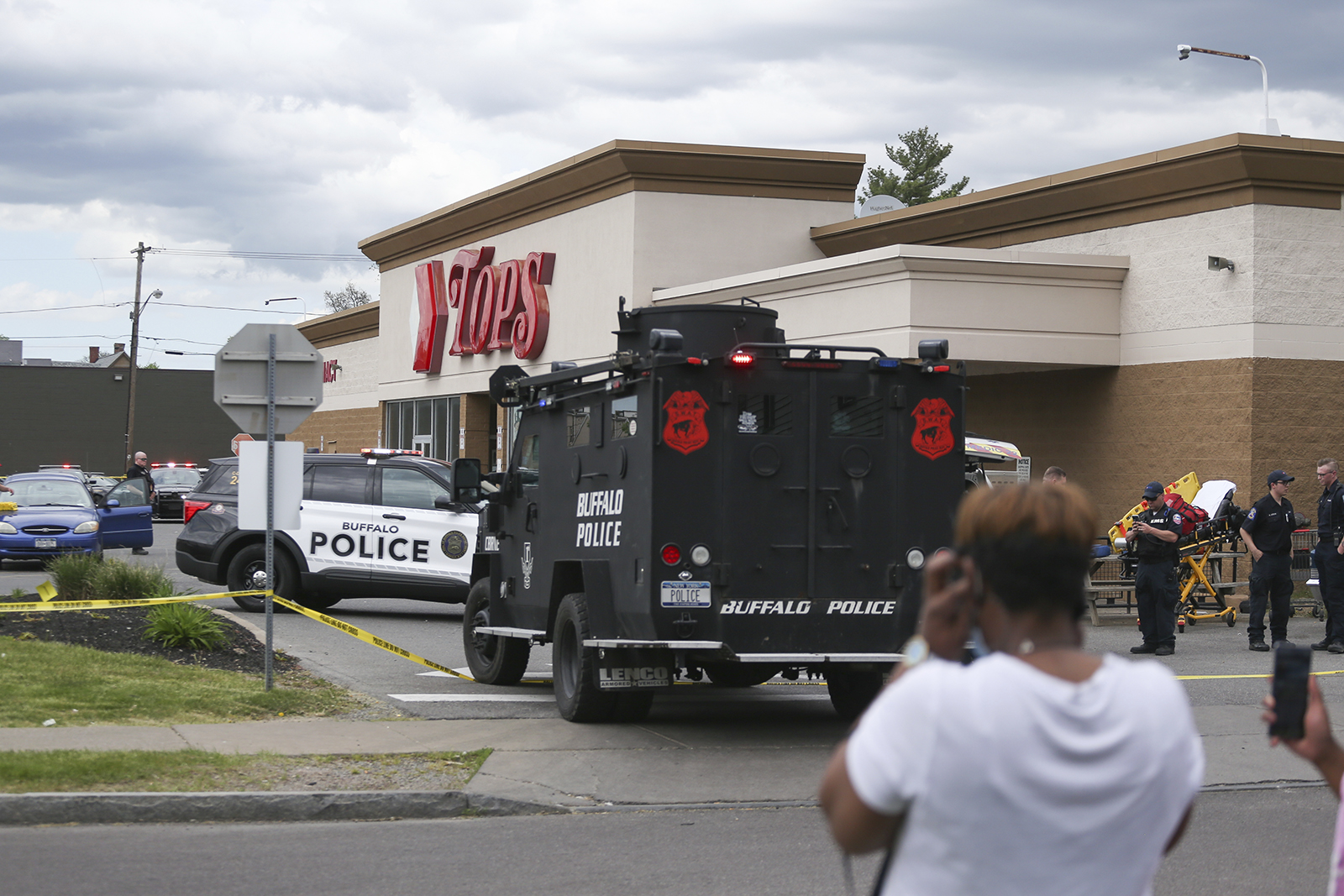 A crowd gathers as police investigate the shooting at a supermarket in Buffalo on Saturday.