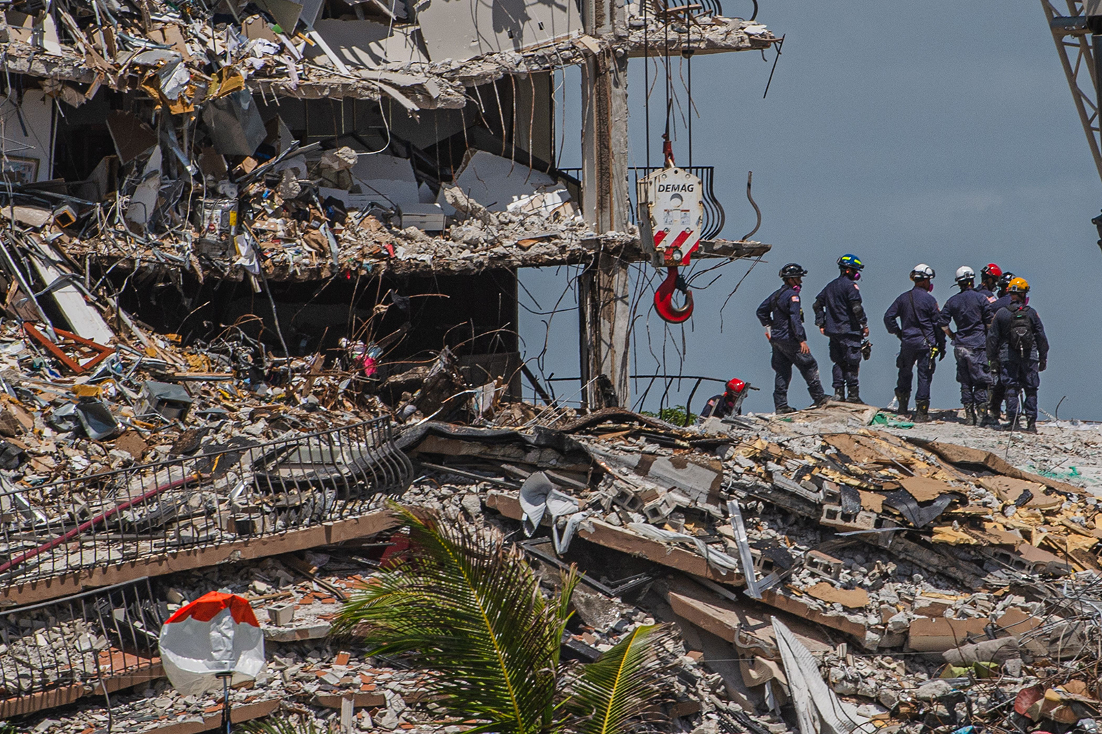 Search and Rescue teams look for possible survivors in the partially collapsed 12-story Champlain Towers South condo building on June 27, in Surfside, Florida.