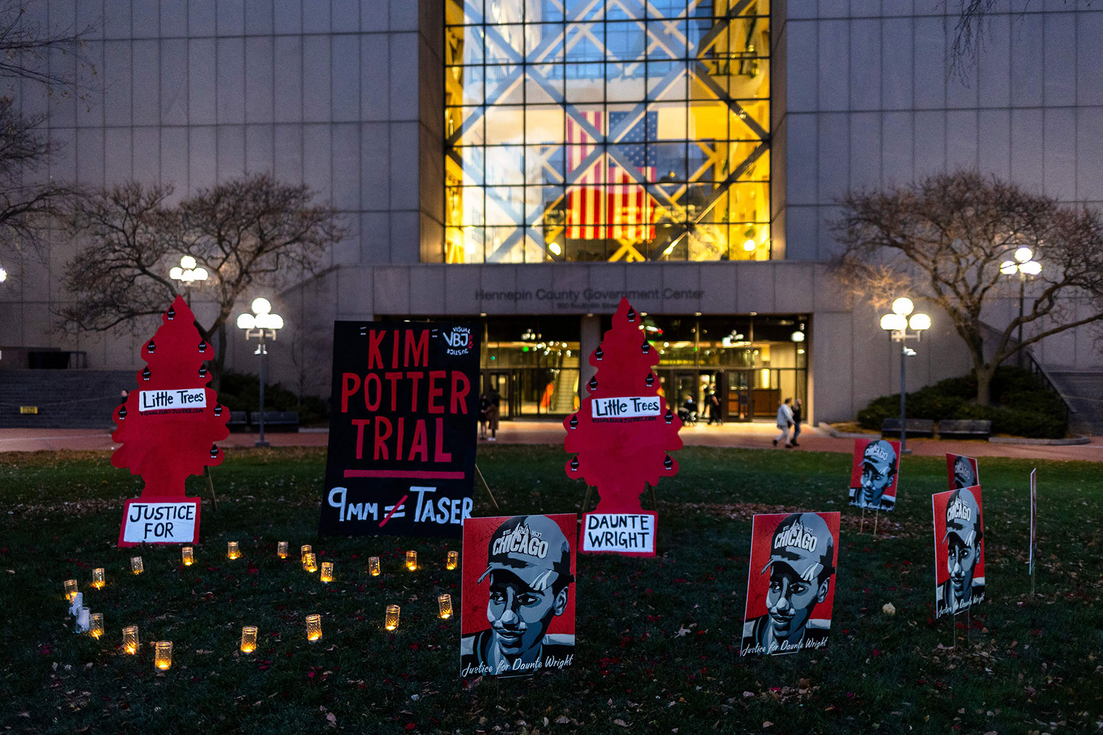 Signs and candles are placed in front of the Hennepin County Government Center in Minneapolis on November 30.