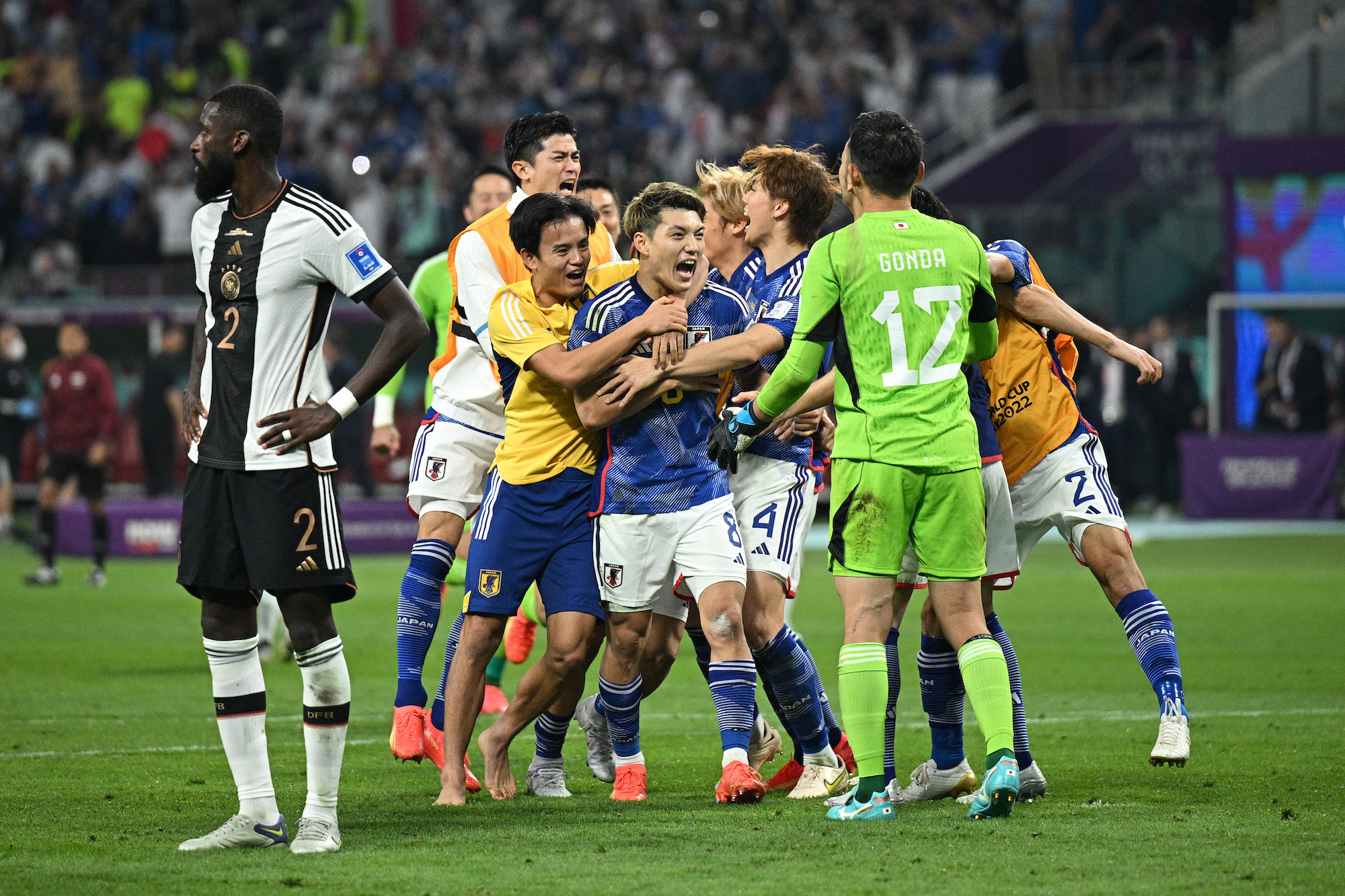 Japan players celebrate their 2-1 win over Germany at Khalifa International Stadium on Wednesday.