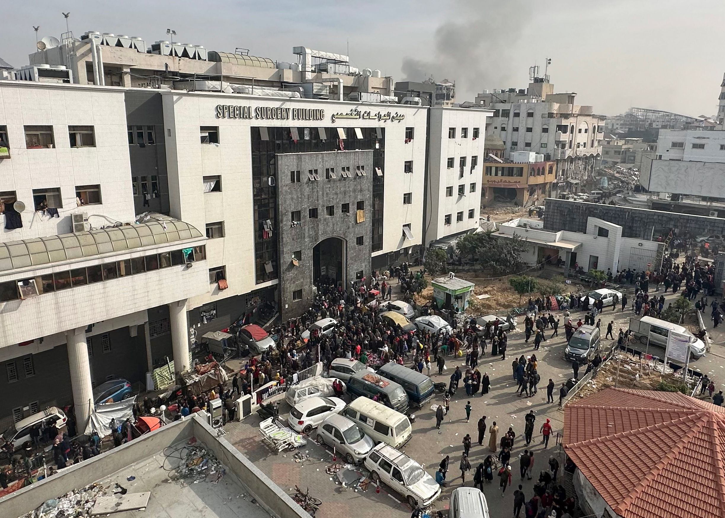 Displaced Palestinians gather in the yard of Al-Shifa hospital in Gaza on December 10, 2023.
