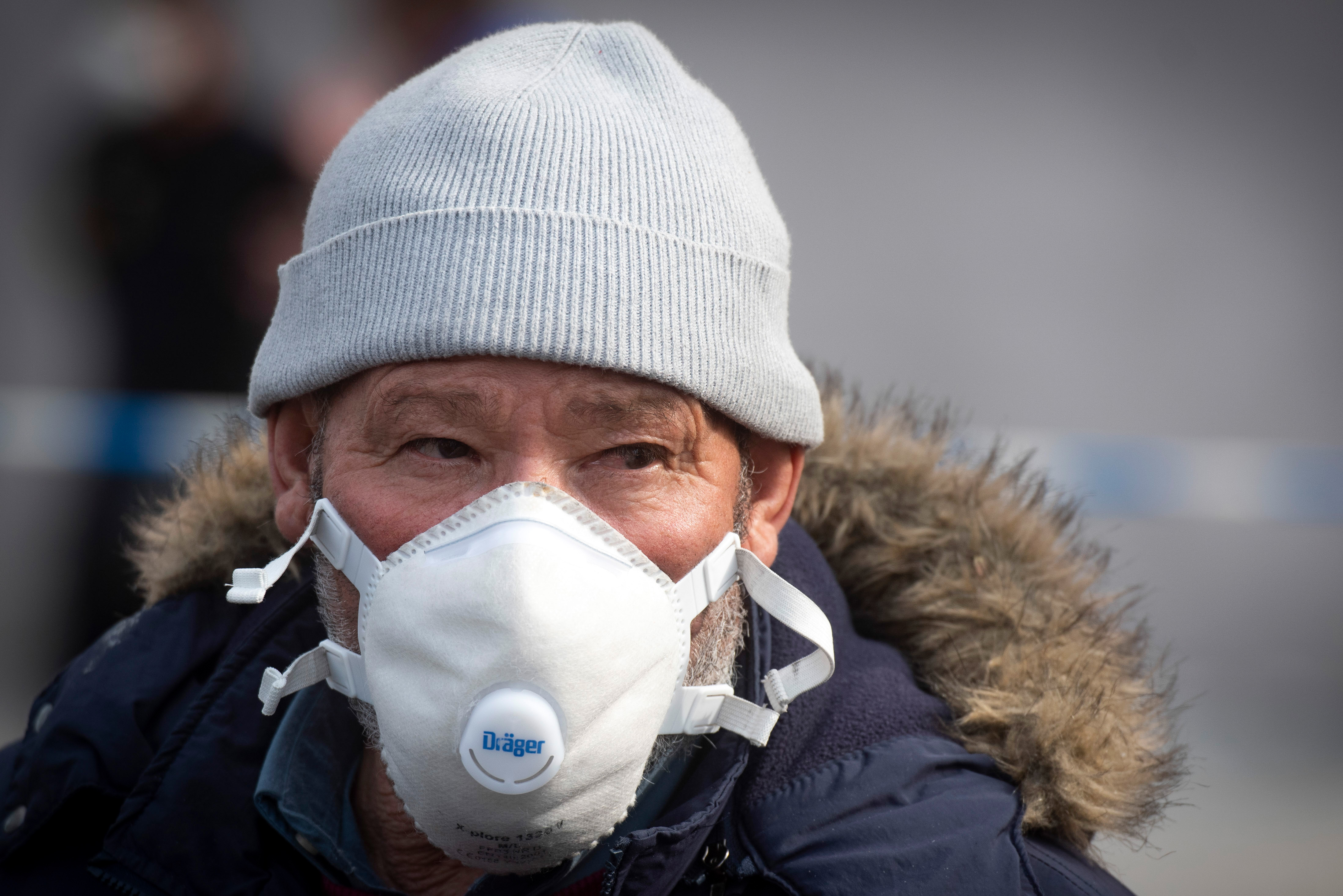 An elderly Moroccan man wearing a protective mask looks on after being stopped from traveling out of the Spanish city of Algeciras by sea amid lockdown measures to prevent the spread of the coronavirus.