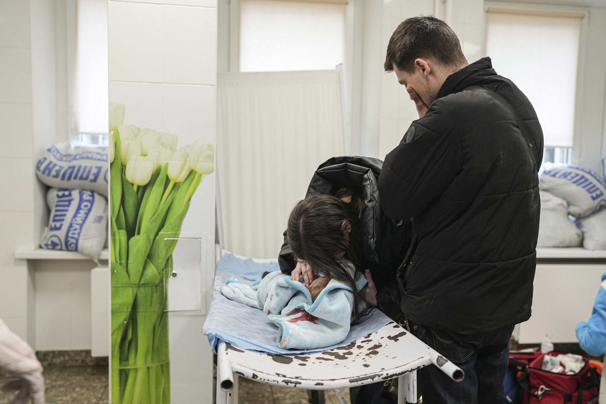 Marina Yatsko with her son Kirill after he died as her boyfriend Fedor looks on.