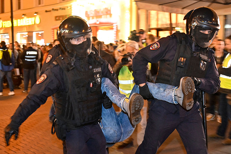 Police officers detain a person in Moscow on Wednesday, September 21.
