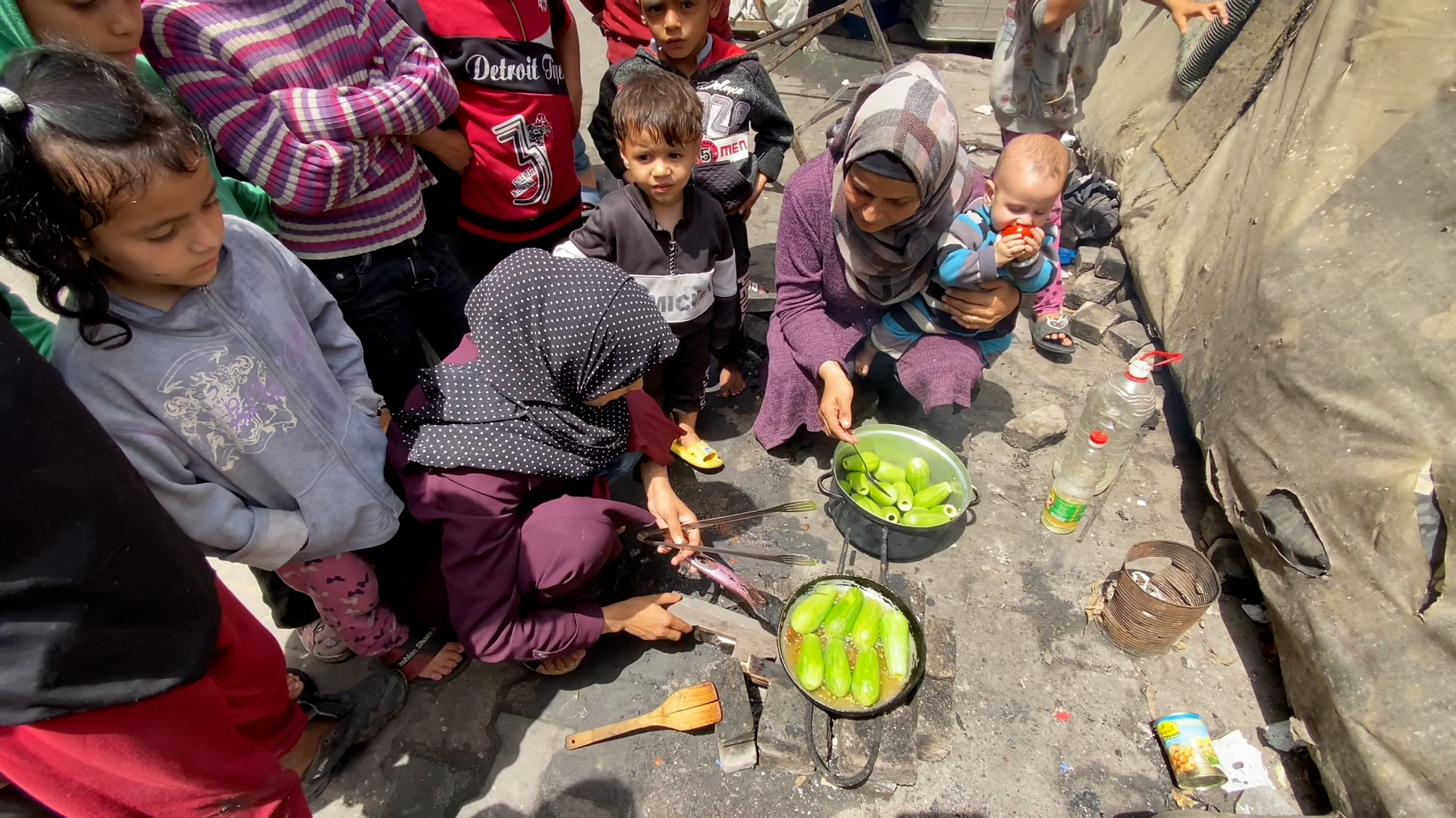 Displaced Palestinians cook in Deir al-Balah, in central Gaza.