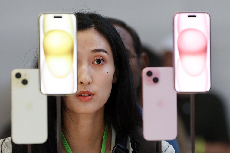 An attendee looks at the brand new Apple iPhone 15 during an Apple event today in Cupertino, California.