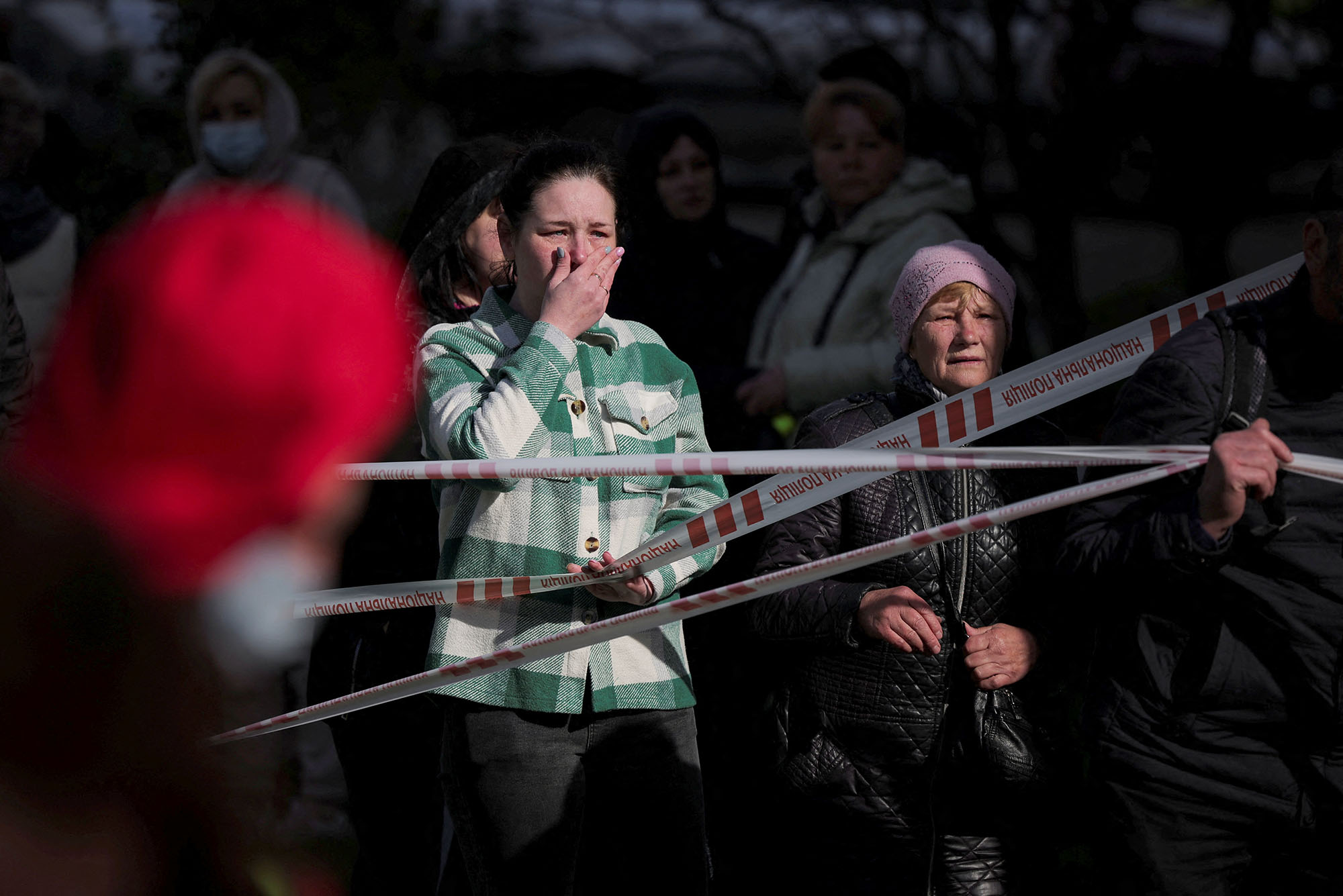 Family members and neighbours react at the site of a heavily damaged residential building hit in the town of Uman, Cherkasy region, Ukraine, on April 28.