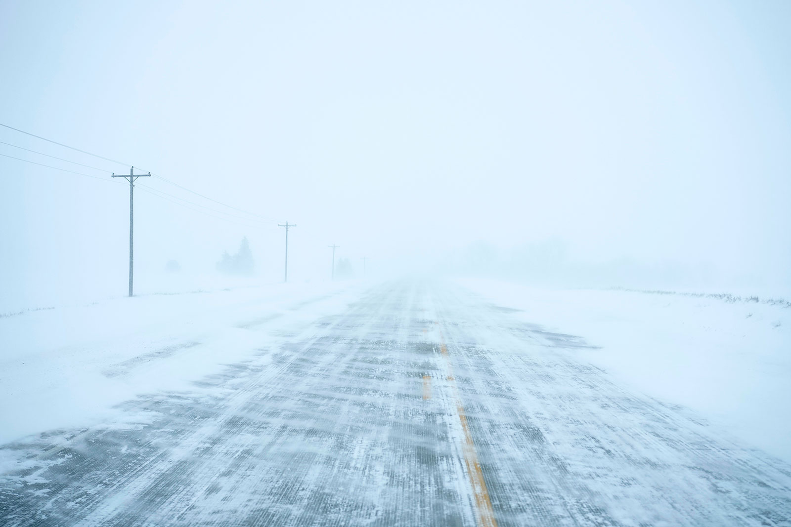 Snow is falling on a county road near Merrill, Iowa, on Friday