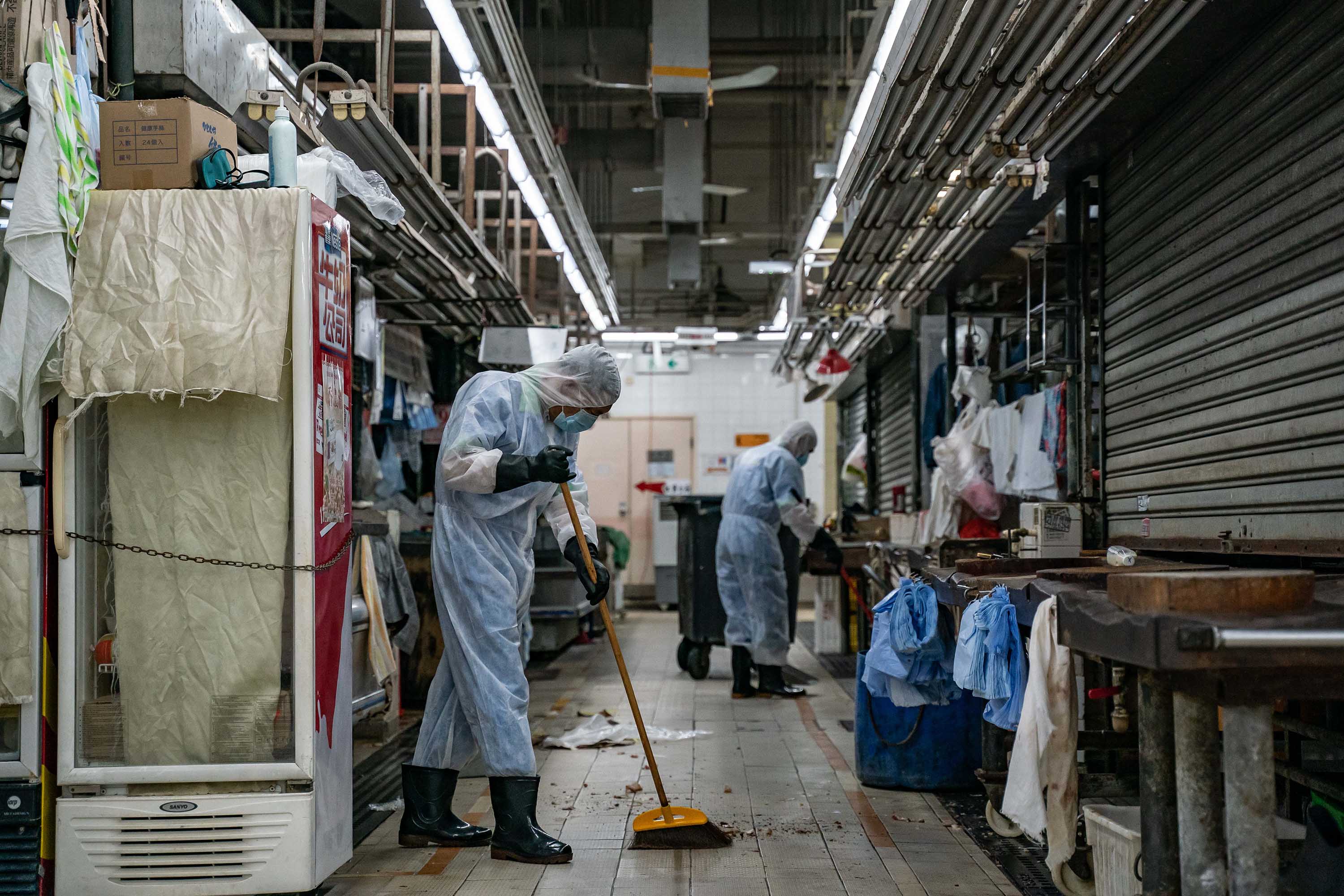 Workers clean and disinfect a wet market in Hong Kong on July 19.