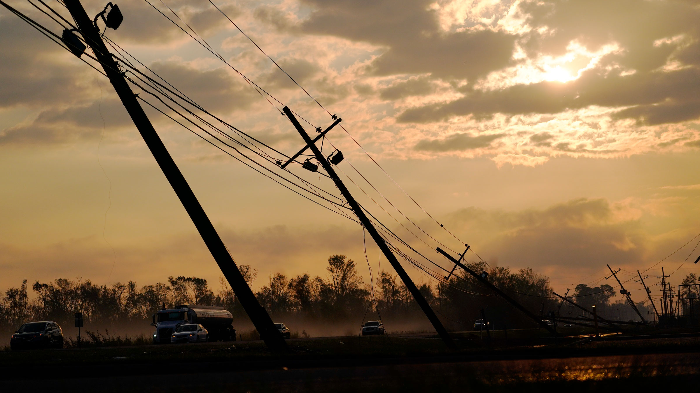 Downed power lines slump over a road in Reserve, Louisiana, on Friday.