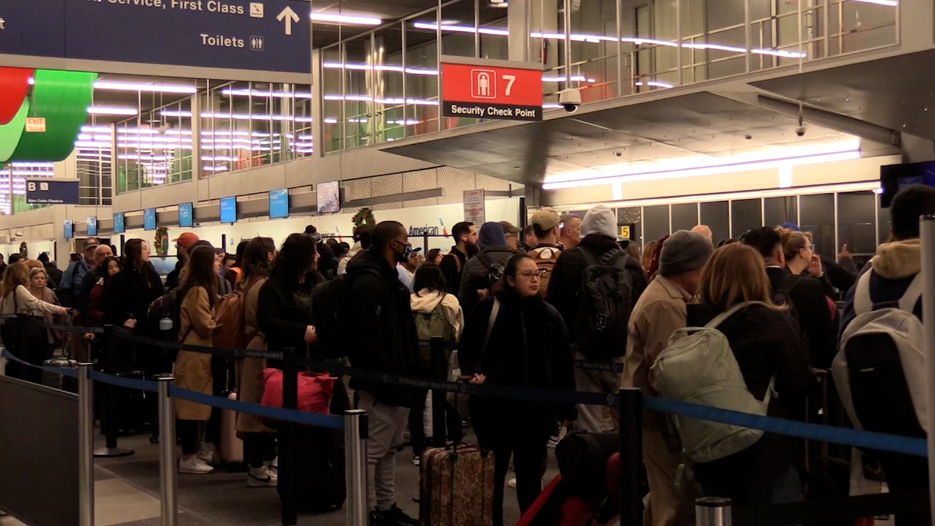 Passengers stand in line at O’Hare International Airport in Chicago on Friday.