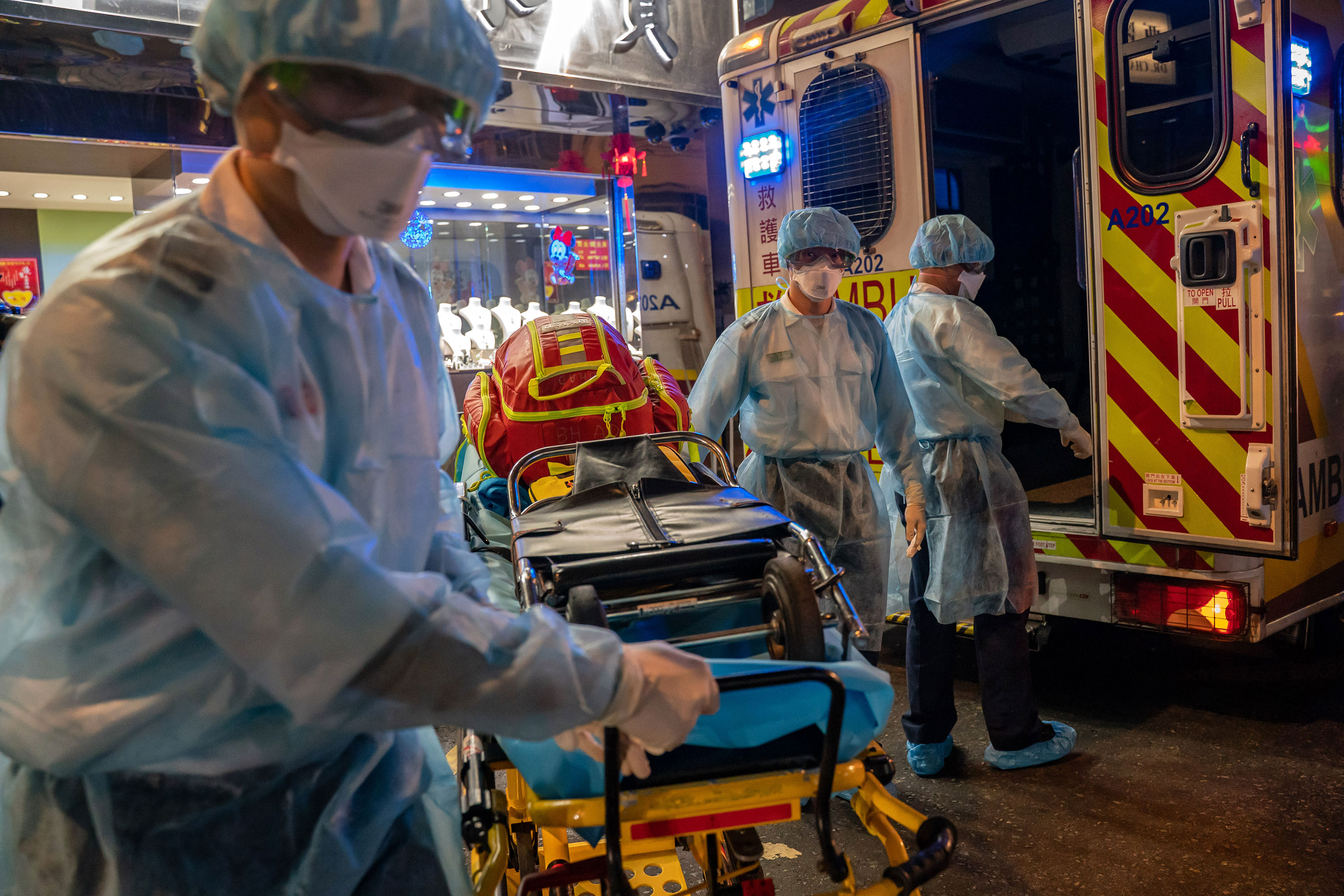 Paramedics carry a stretcher off an ambulance in Hong Kong on February 23.